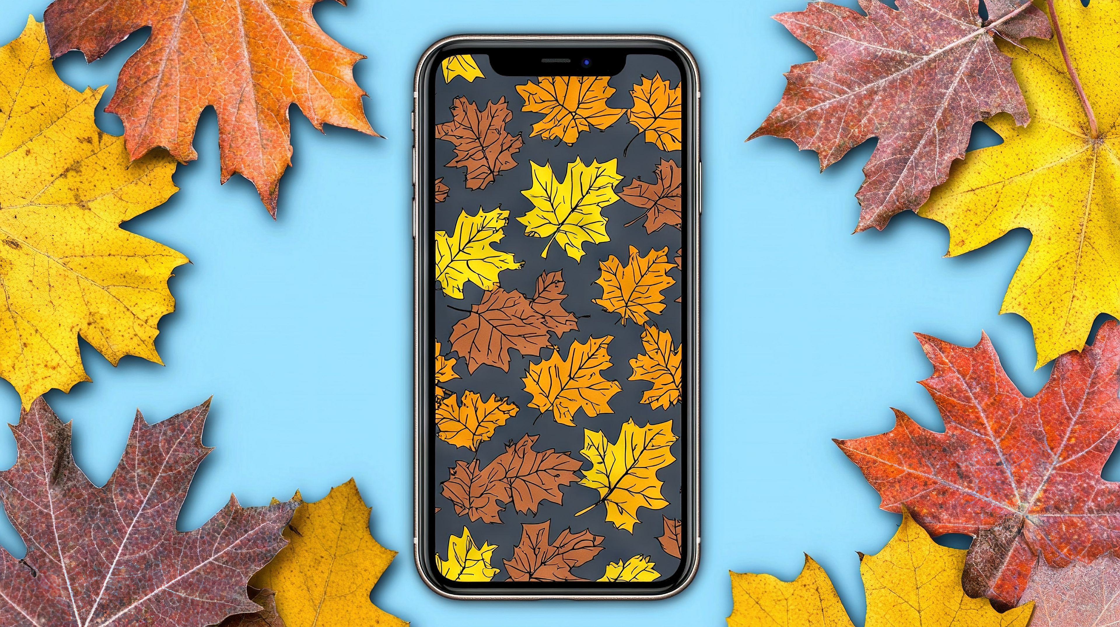 A cell phone rests on a blue background with autumn leaves in orange, yellow, red, and green shades surrounding it.