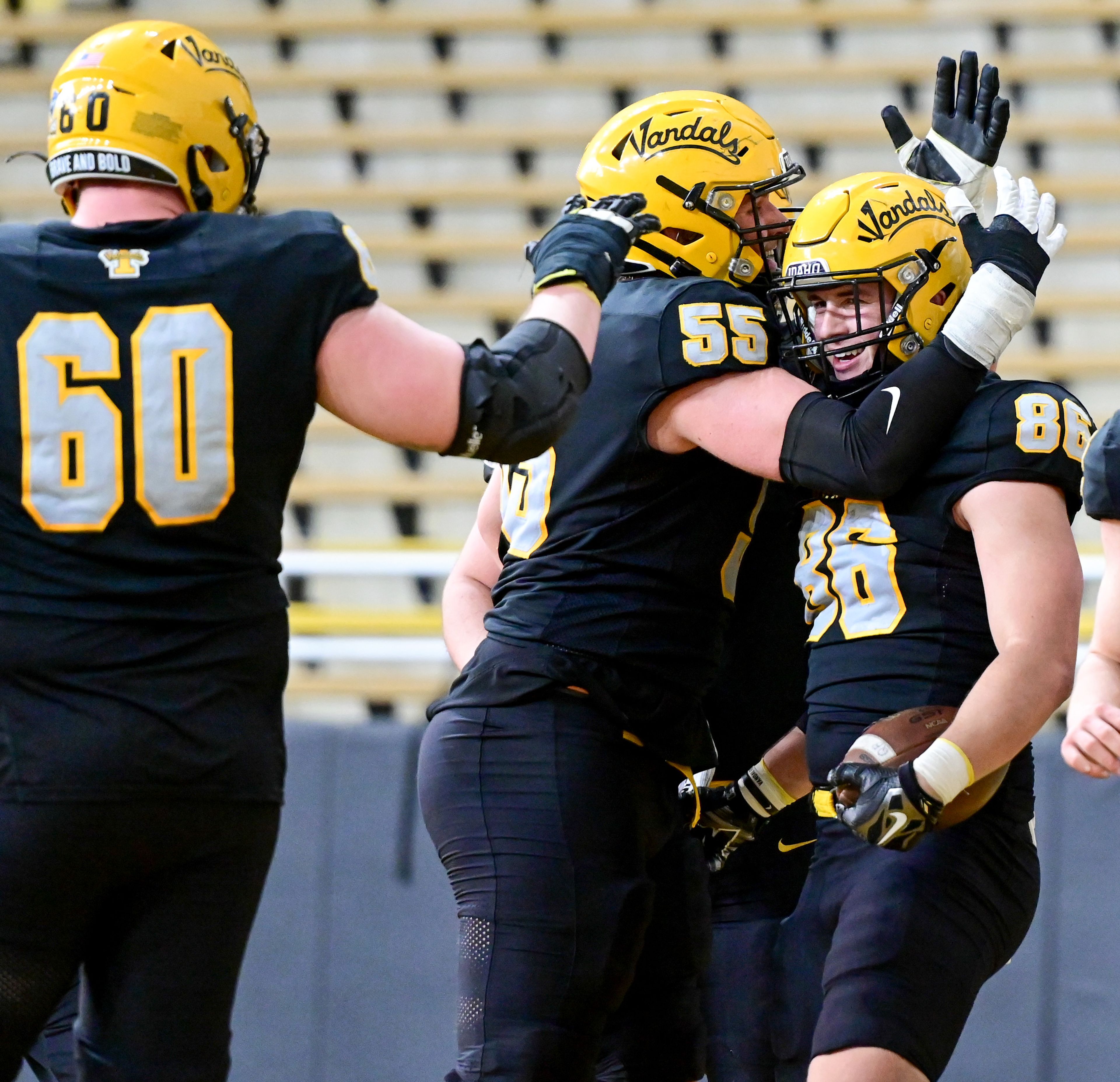 Vandal teammates celebrate tight end Mason Mini's (86) touchdown during the annual spring game at the P1FCU Kibbie Dome in Moscow on Friday.