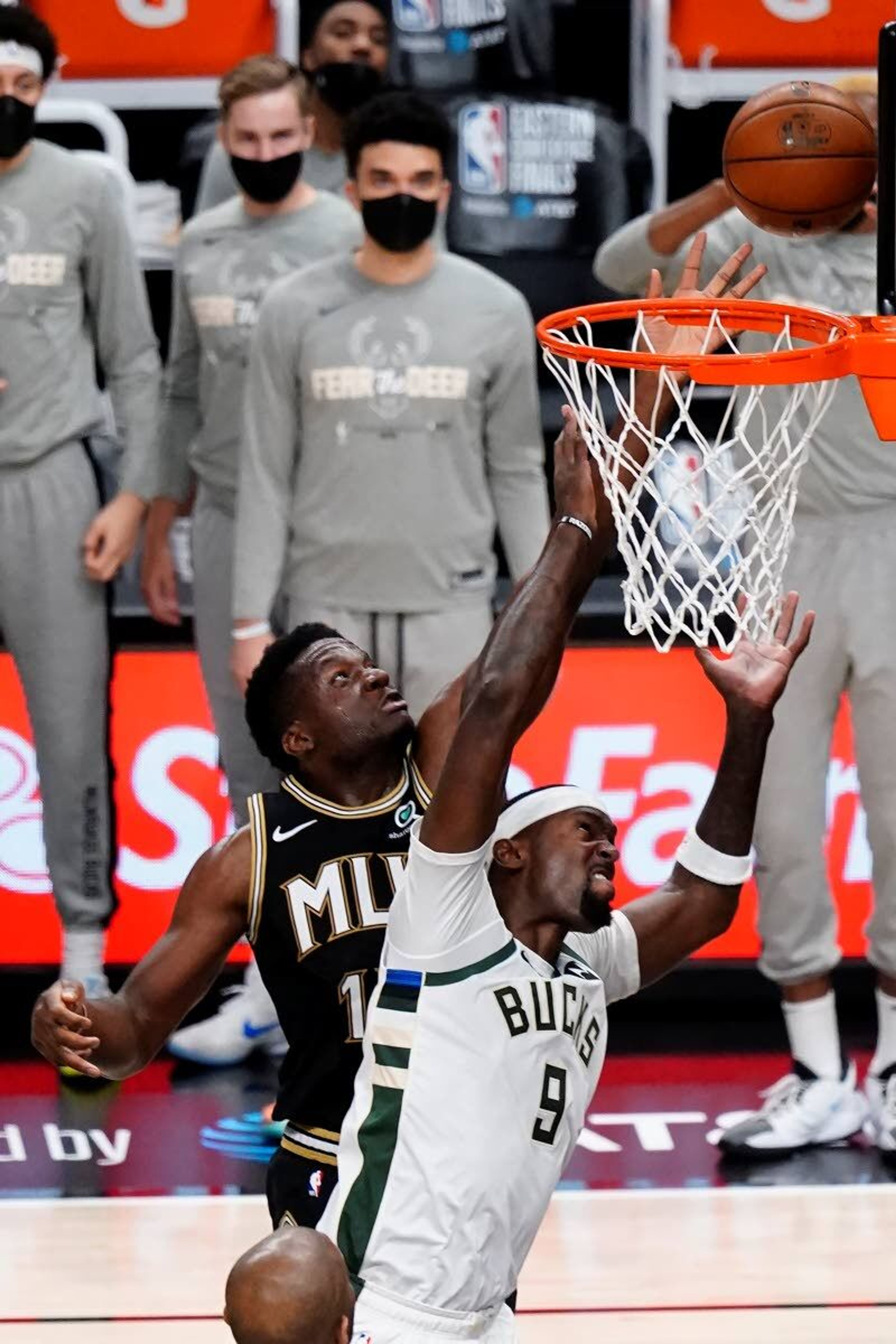 Milwaukee Bucks center Bobby Portis (9) defends as Atlanta Hawks center Clint Capela (15) goes up to shoot during the first half in Game 6 of the Eastern Conference finals in the NBA basketball playoffs Saturday, July 3, 2021, in Atlanta. (AP Photo/John Bazemore)