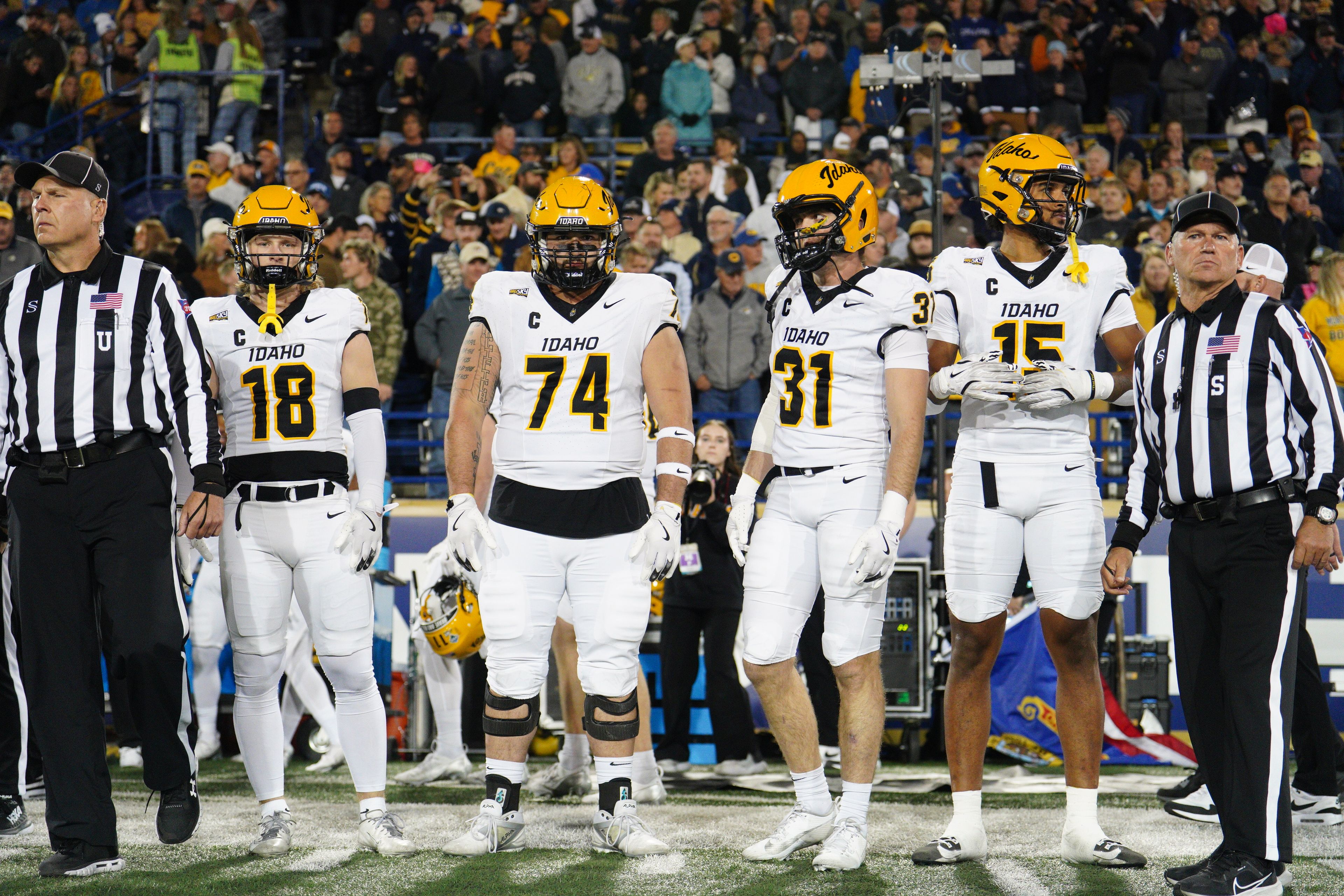 Idaho Vandals defensive back Tommy McCormick, defensive lineman Malakai Williams, linebacker Mathias Bertram and offensive lineman Nate Azzopardi stand on the sideline during a game on Saturday, Oct. 12, 2024, in Bozeman, Mont.