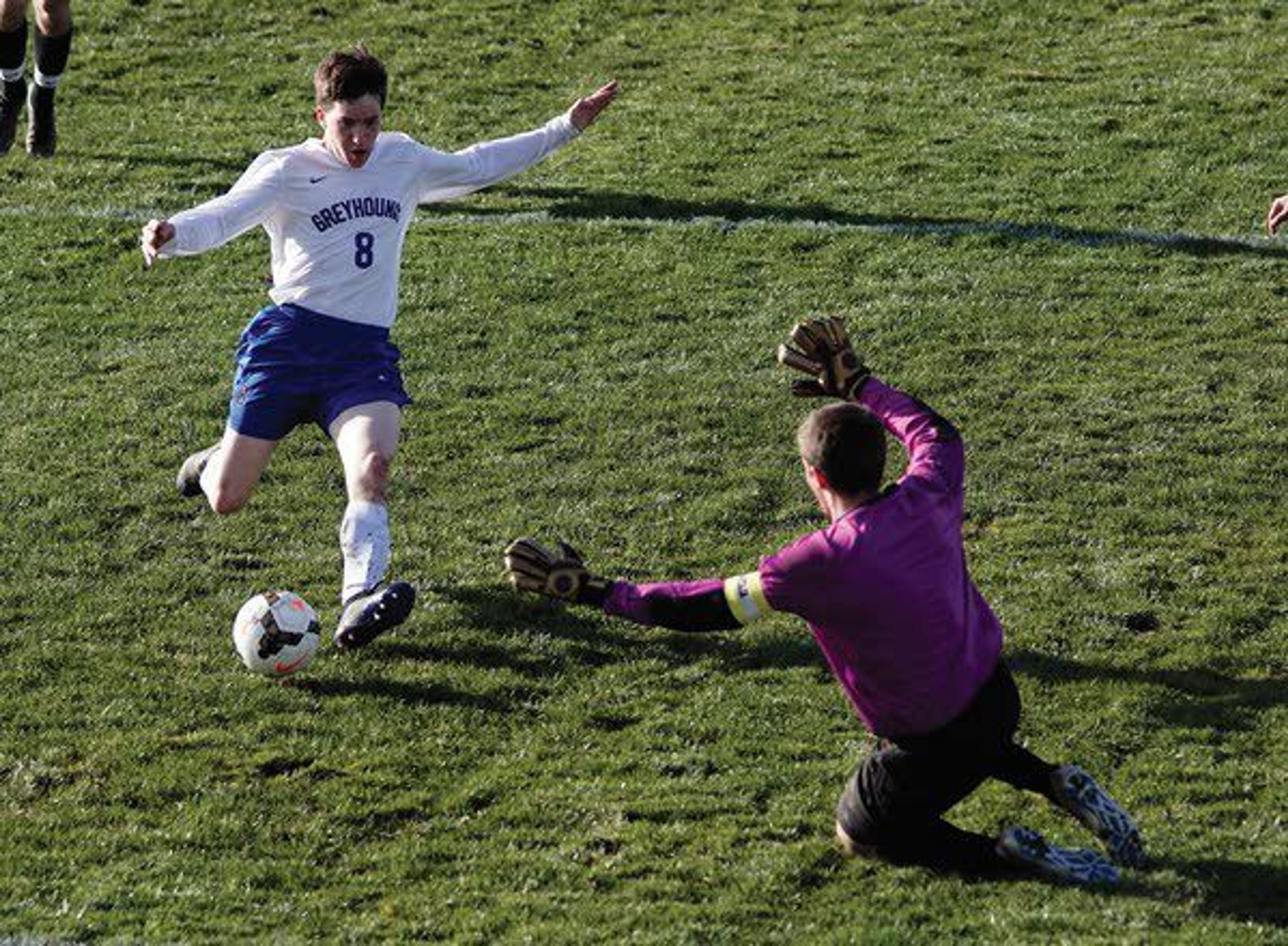 Pullman forward Sebastien Lewis (8) tries to drive the ball past East Valley keeper Kohl Tomcho near the end of regulation Tuesday afternoon in Pullman.