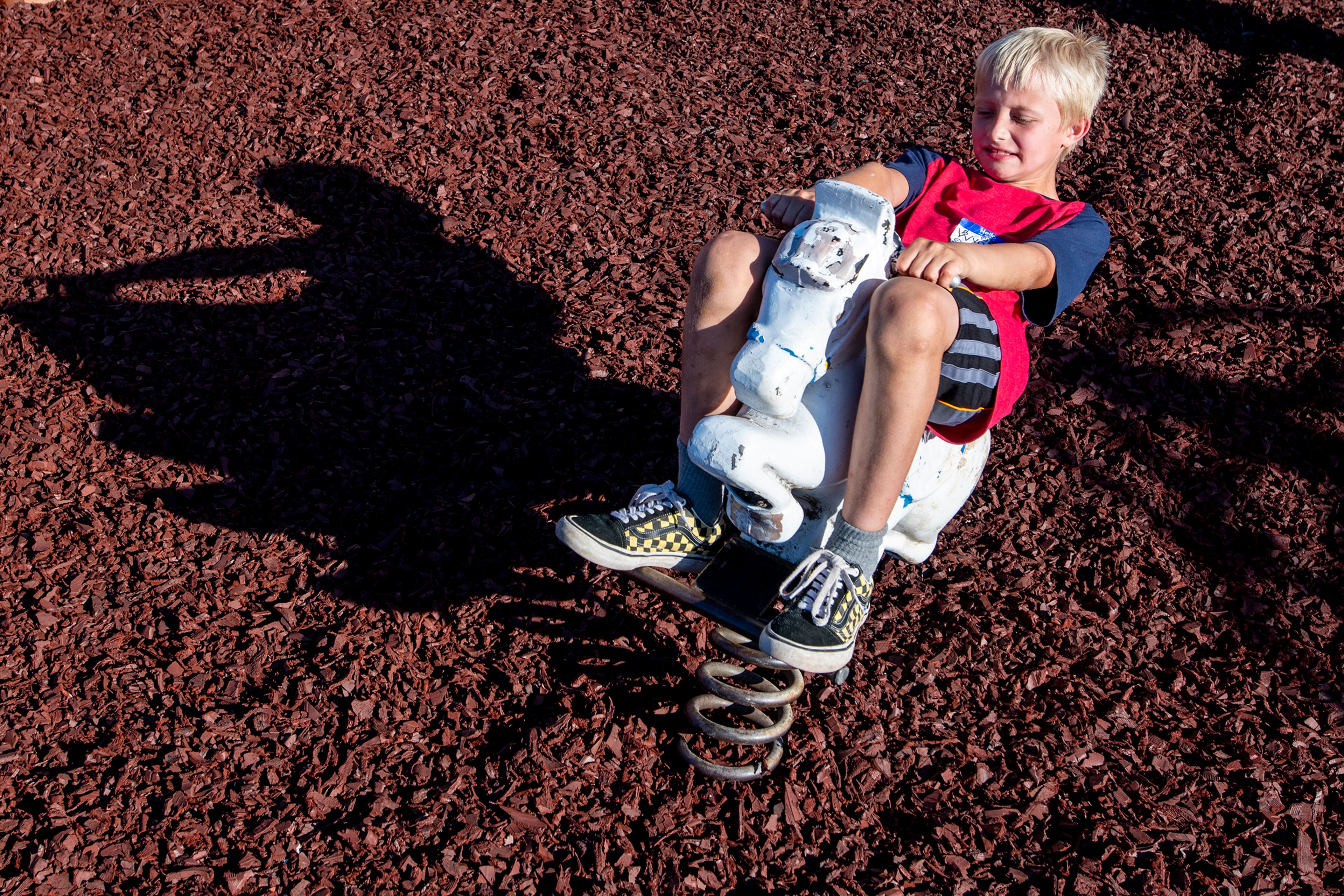 Wyatt Humphrey, 8, rides a horse Thursday evening on the Viola Community Center playground.