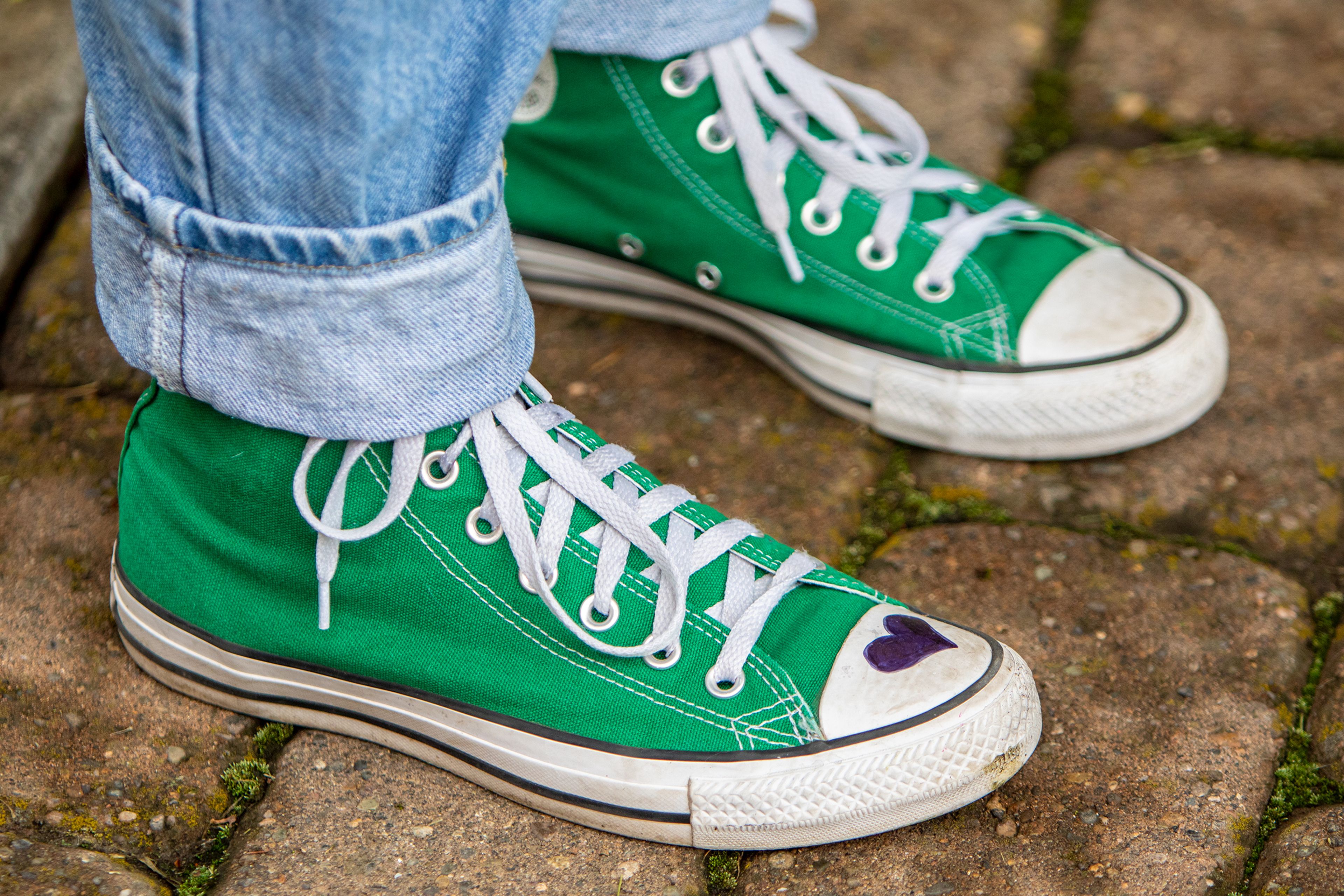 Lewiston High student Sophia Gill wears lime green Converse tennis shoes with a heart drawn over the right toe in memory of 10-year-old Uvalde shooting victim Maite Yuleana Rodriguez during a March for Our Lives rally Saturday morning at Brackenbury Square in downtown Lewiston. Rodriguez wore a pair just like these and they were the only piece of unidentifiable evidence to ID her after the shooting.