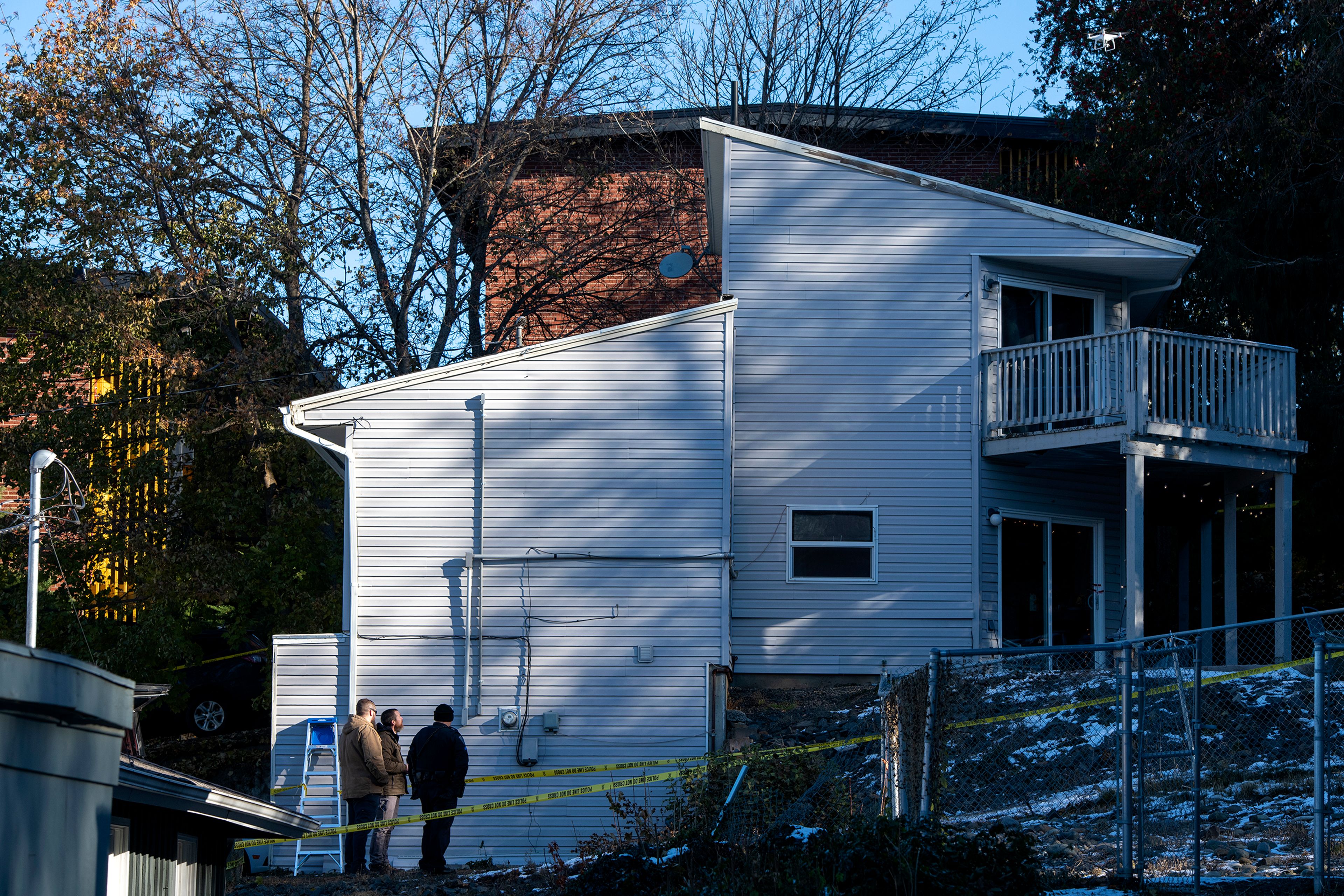 Officers fly a drone above the crime scene Friday at a home where four University of Idaho students were recently murdered over the weekend in Moscow.