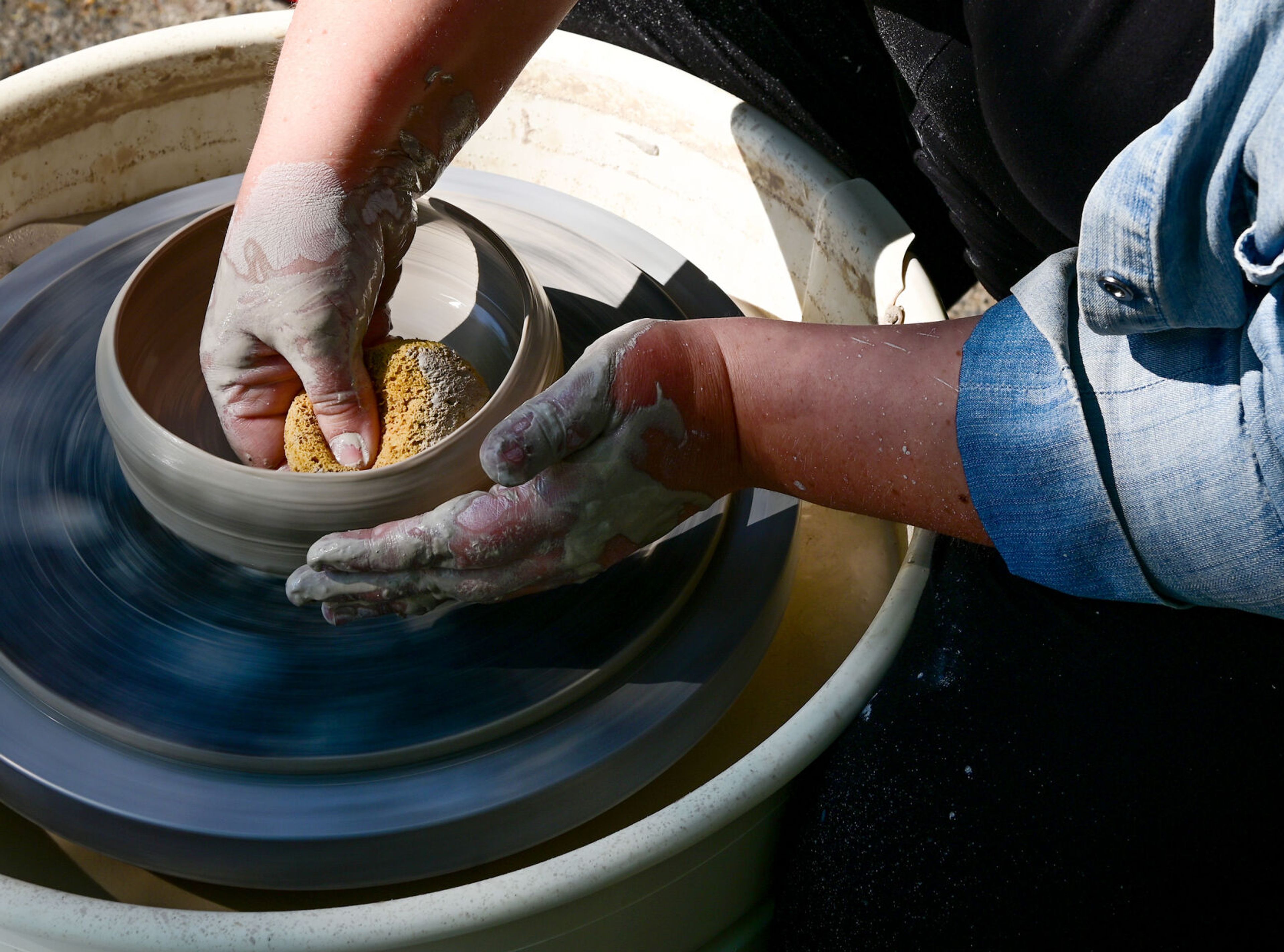 Owner and founder Candace Baltz creates forms wet clay on a potter's wheel on Wednesday outside of Terracotta’s new downtown Moscow space.