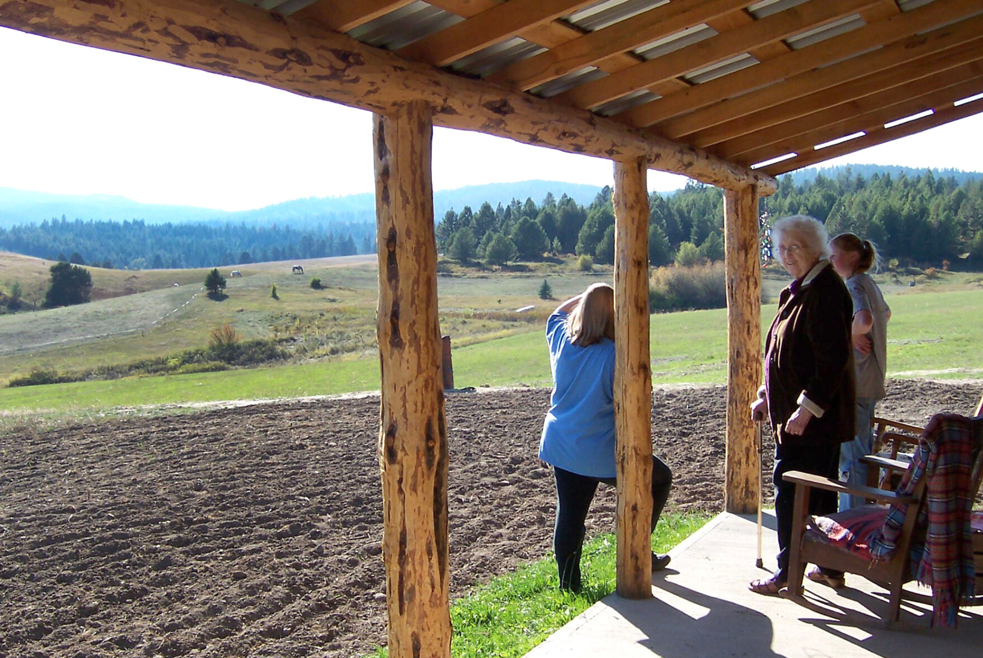 Robyn Peterson, left, Margaret Bull, center, and Greta Lovell visit on the cabin's front porch in 2003. (Andy Bull photo)