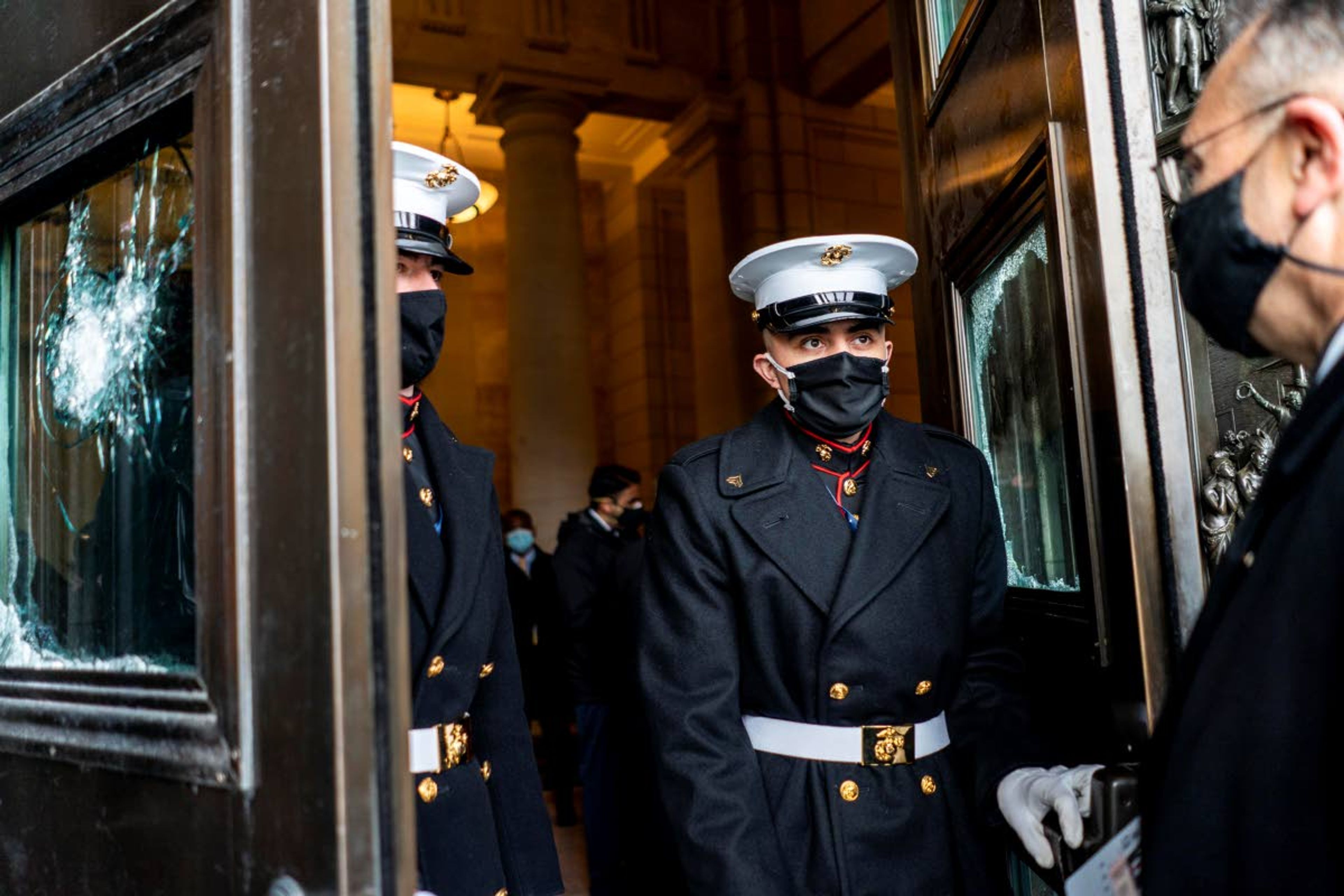 U.S. Marine Corps. stand in the doorway between damaged Capitol doors during a rehearsal for the 59th inaugural ceremony for President-elect Joe Biden and Vice President-elect Kamala Harris on Monday, Jan. 18, 2021 at the U.S. Capitol in Washington. (Melina Mara/The Washington Post via AP, Pool)