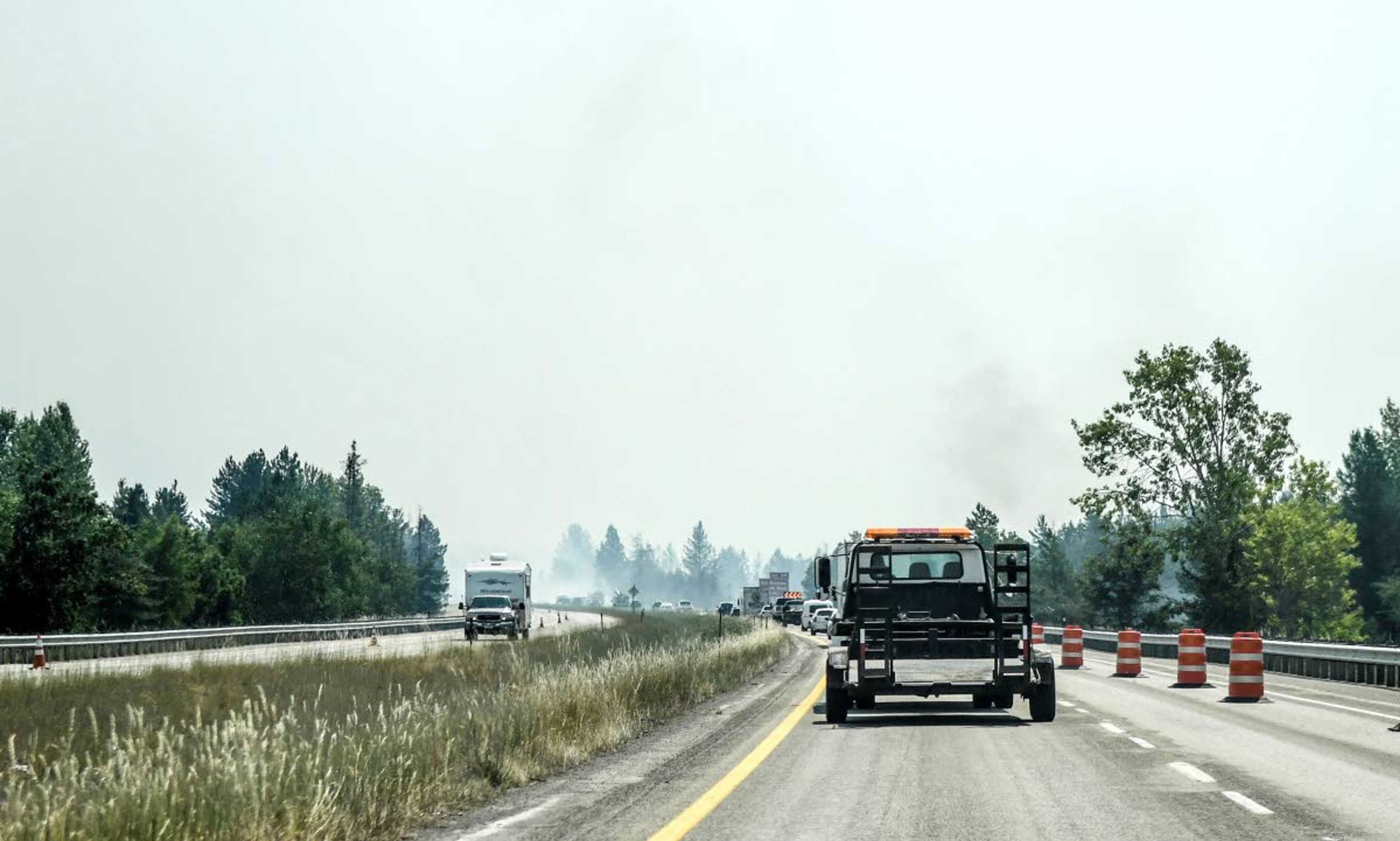 A section of I-90 is down to one lane due to heavy smoke near Cataldo, Idaho caused by fires in the area, Wednesday, July 7, 2021. (Kathy Plonka/The Spokesman-Review via AP)