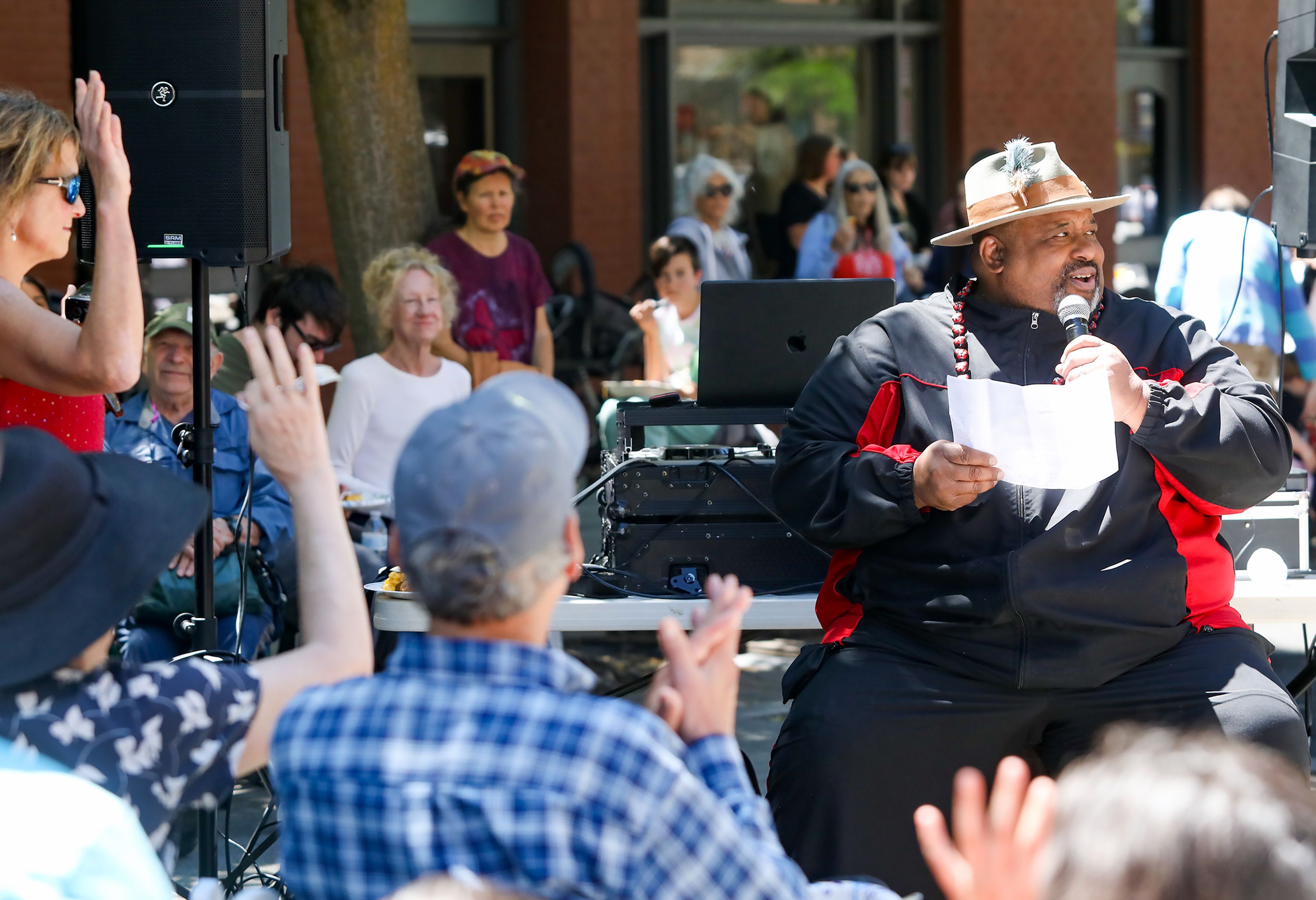 The crowd reacts to James Montgomery Bledsoe, right, asking if they’ve heard of Maya Angelou before reading a poem of Angelou’s at the Juneteenth celebration in Friendship Square on Wednesday in Moscow.