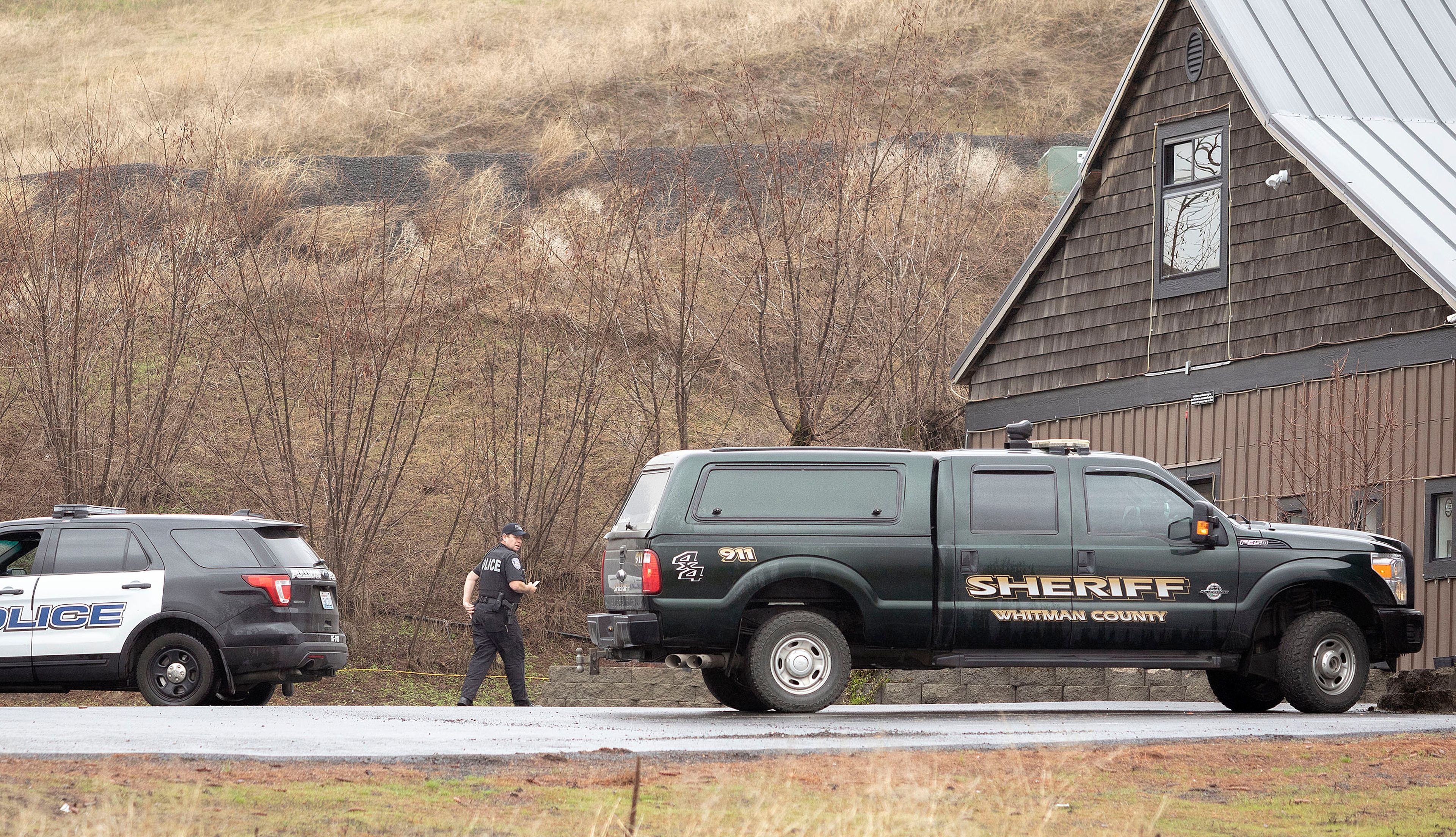 A Pullman police officer walks into Bud Hut while investigating an armed robbery at the business on Monday east of Pullman.