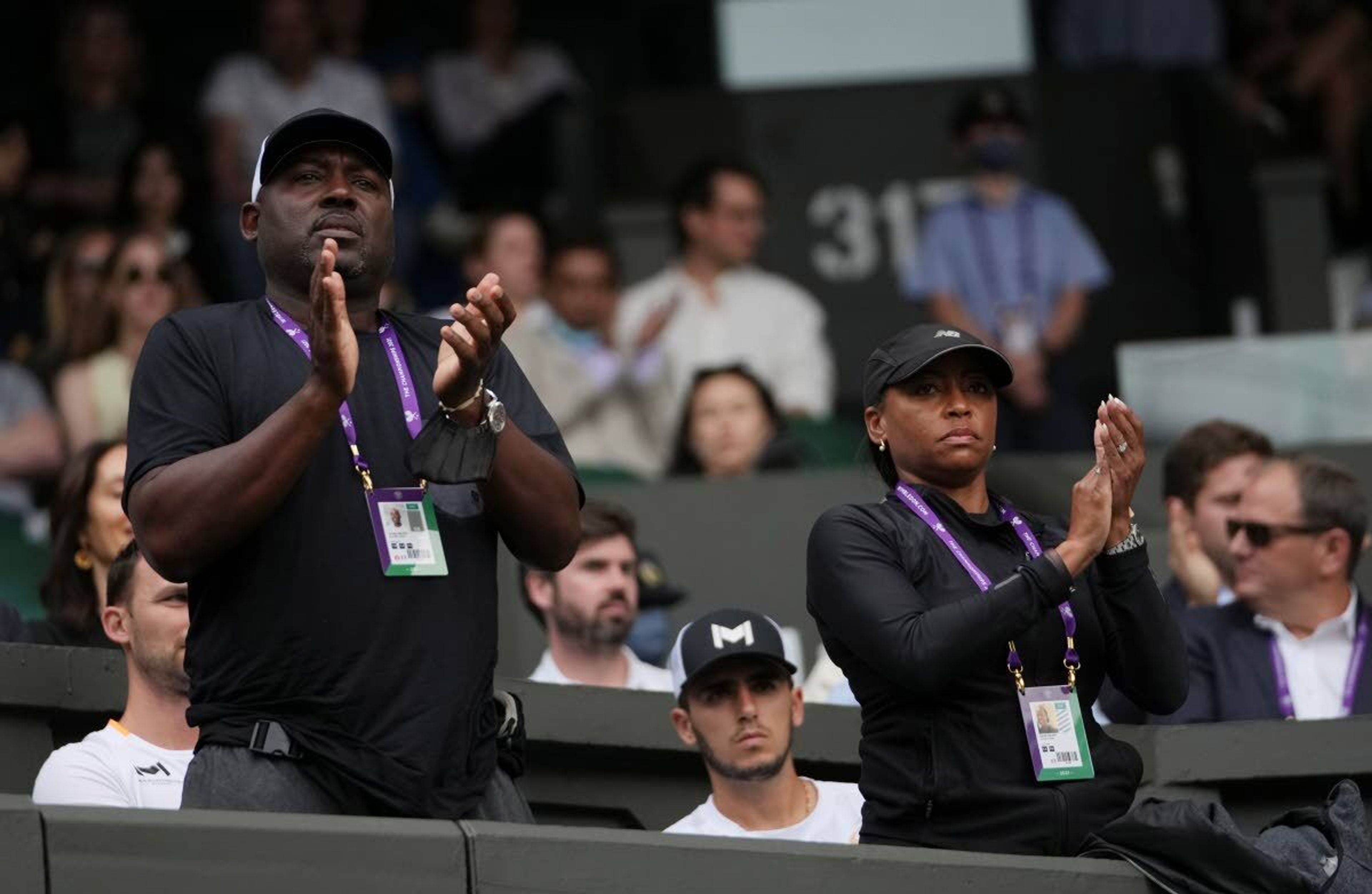 The parents of Coco Gauff of the US applaud during the women's singles second round match against Russia's Elena Vesnina on day four of the Wimbledon Tennis Championships in London, Thursday July 1, 2021. (AP Photo/Alberto Pezzali)