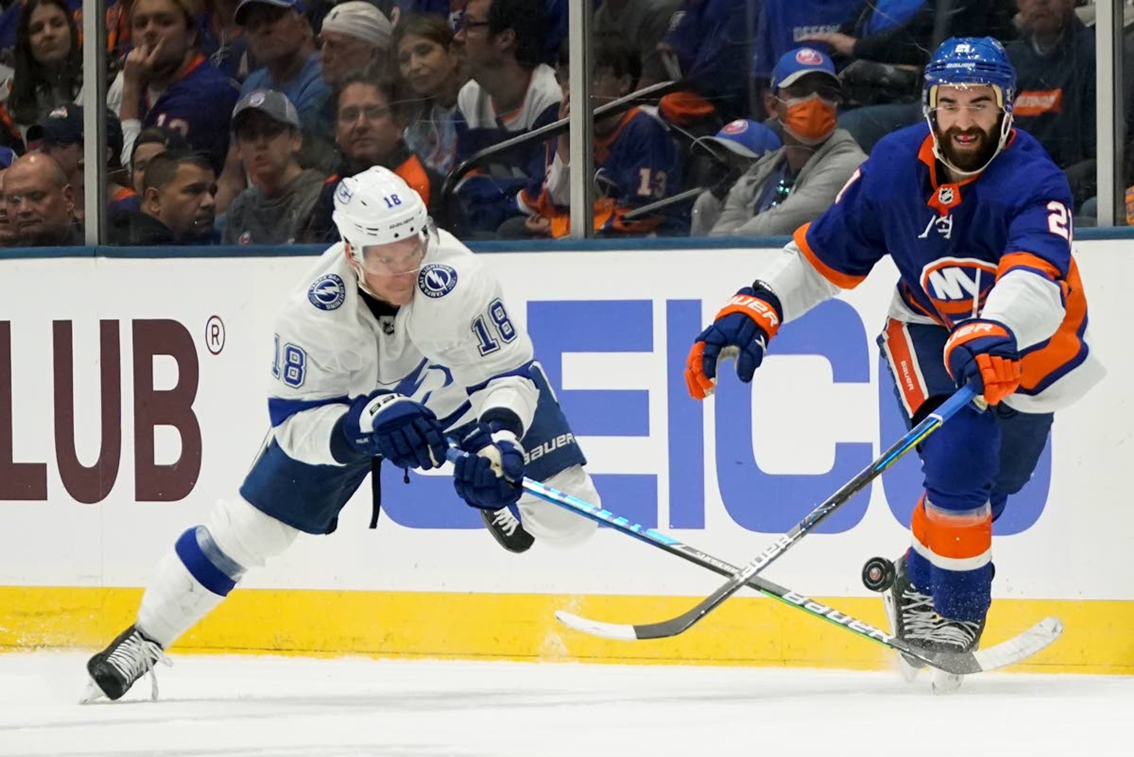 Tampa Bay Lightning left wing Ondrej Palat (18) and New York Islanders right wing Kyle Palmieri (21) battle for control of the puck during the second period of Game 6 of the NHL hockey Stanley Cup semifinals, Wednesday, June 23, 2021, in Uniondale, N.Y. (AP Photo/Frank Franklin II)