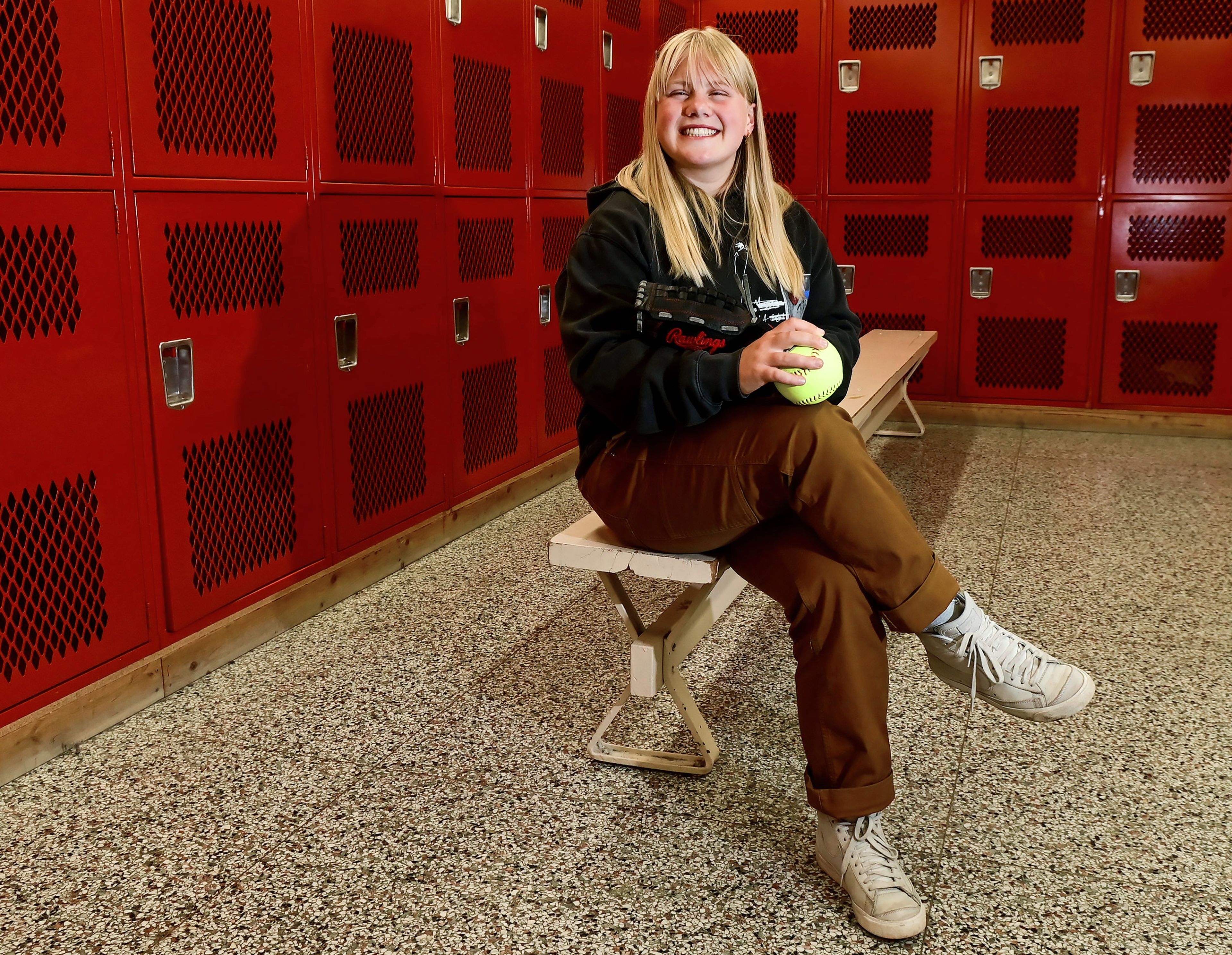 Graduating Moscow High School senior Addison Branen poses with her glove and a softball in the school’s locker room on Tuesday. Branen is a 4.0 student who is signed to play college softball.