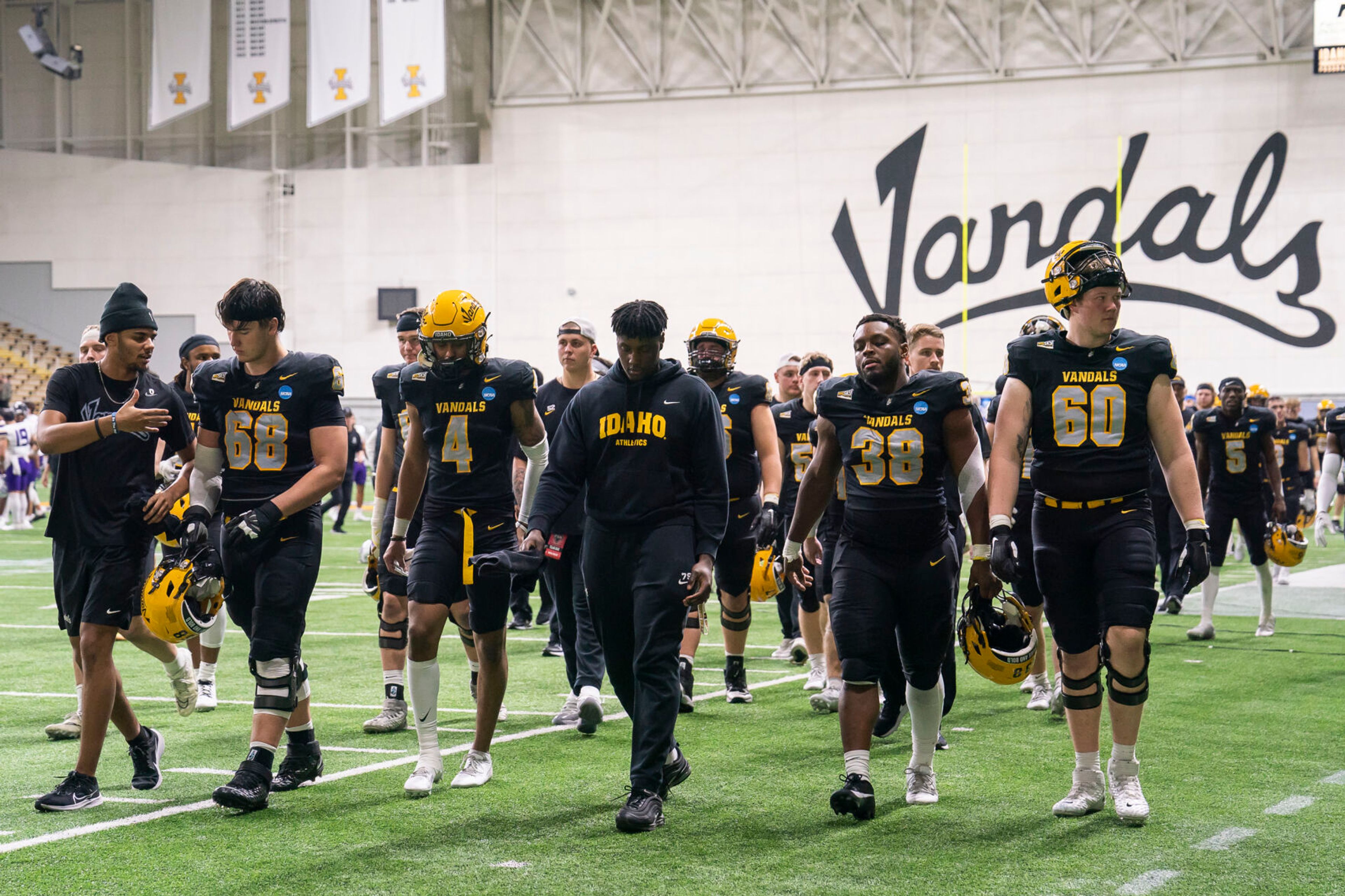 Idaho Vandals players walk to the locker room after losing their game against Albany 22-30 in the third round of the 2023 Division I FCS Football Championship on Saturday inside the Kibbie Dome in Moscow.