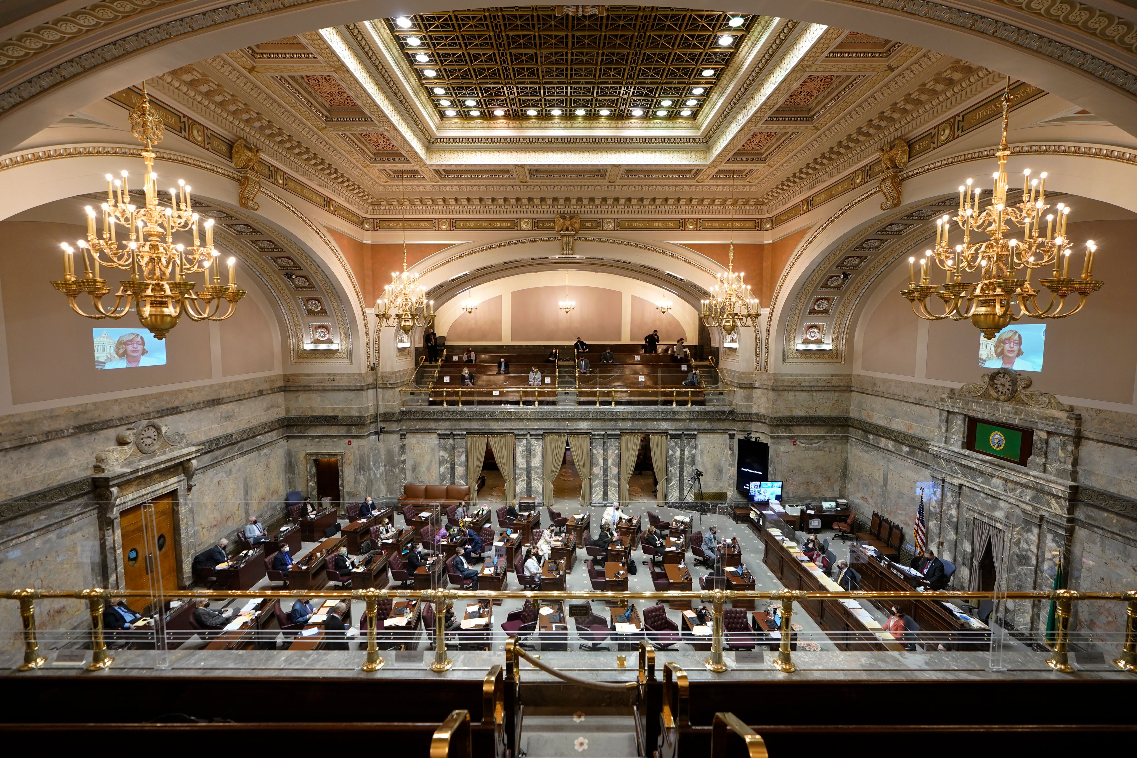 Lawmakers meet on the Senate floor, Thursday, March 10, 2022, at the Capitol in Olympia, Wash. Washington lawmakers were wrapping up their work Thursday with final votes on a supplemental state budget and a transportation revenue package before planning to adjourn the legislative session. (AP Photo/Ted S. Warren)