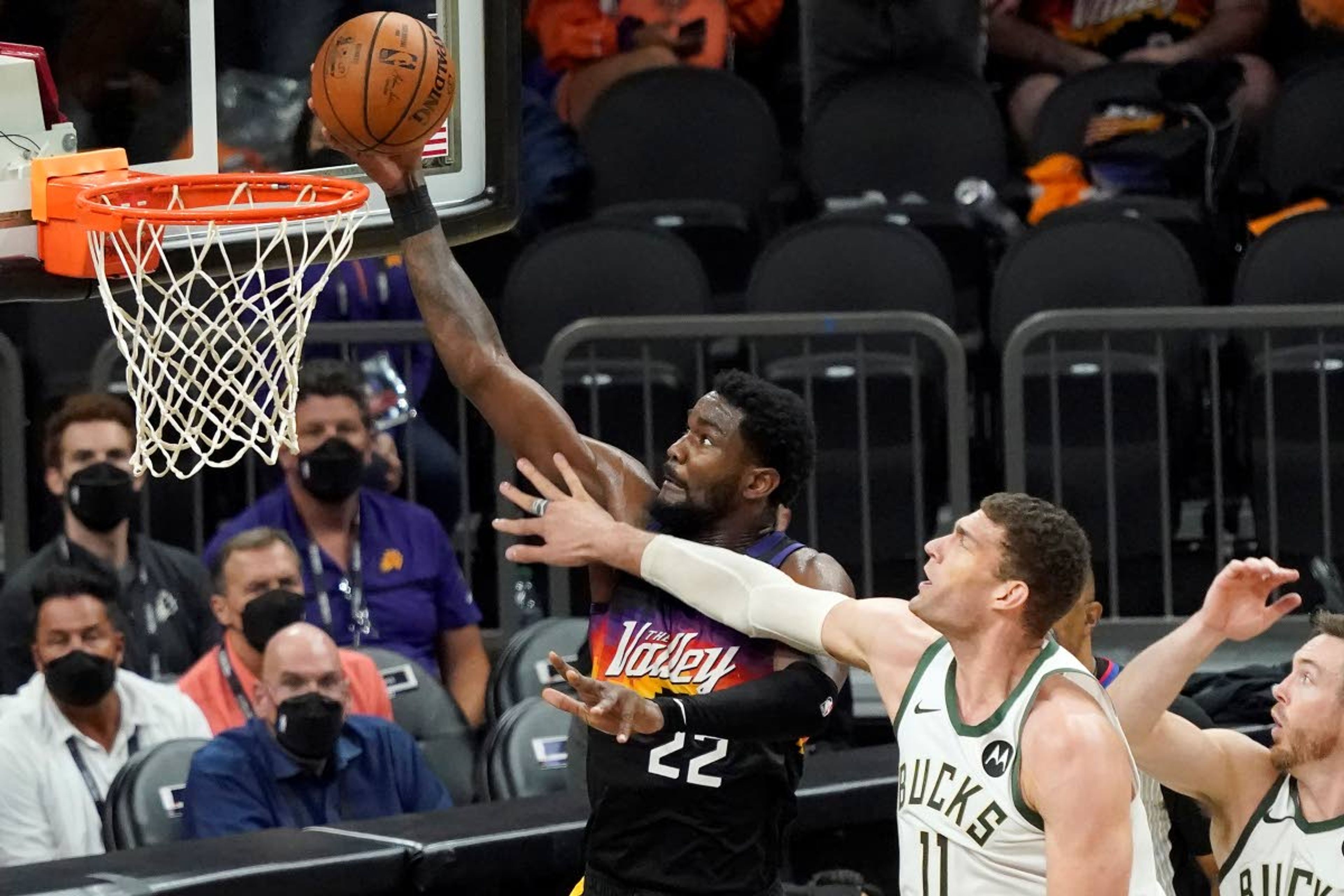 Phoenix Suns center Deandre Ayton (22) shoots against Milwaukee Bucks center Brook Lopez (11) during the second half of Game 2 of basketball's NBA Finals, Thursday, July 8, 2021, in Phoenix. (AP Photo/Matt York)