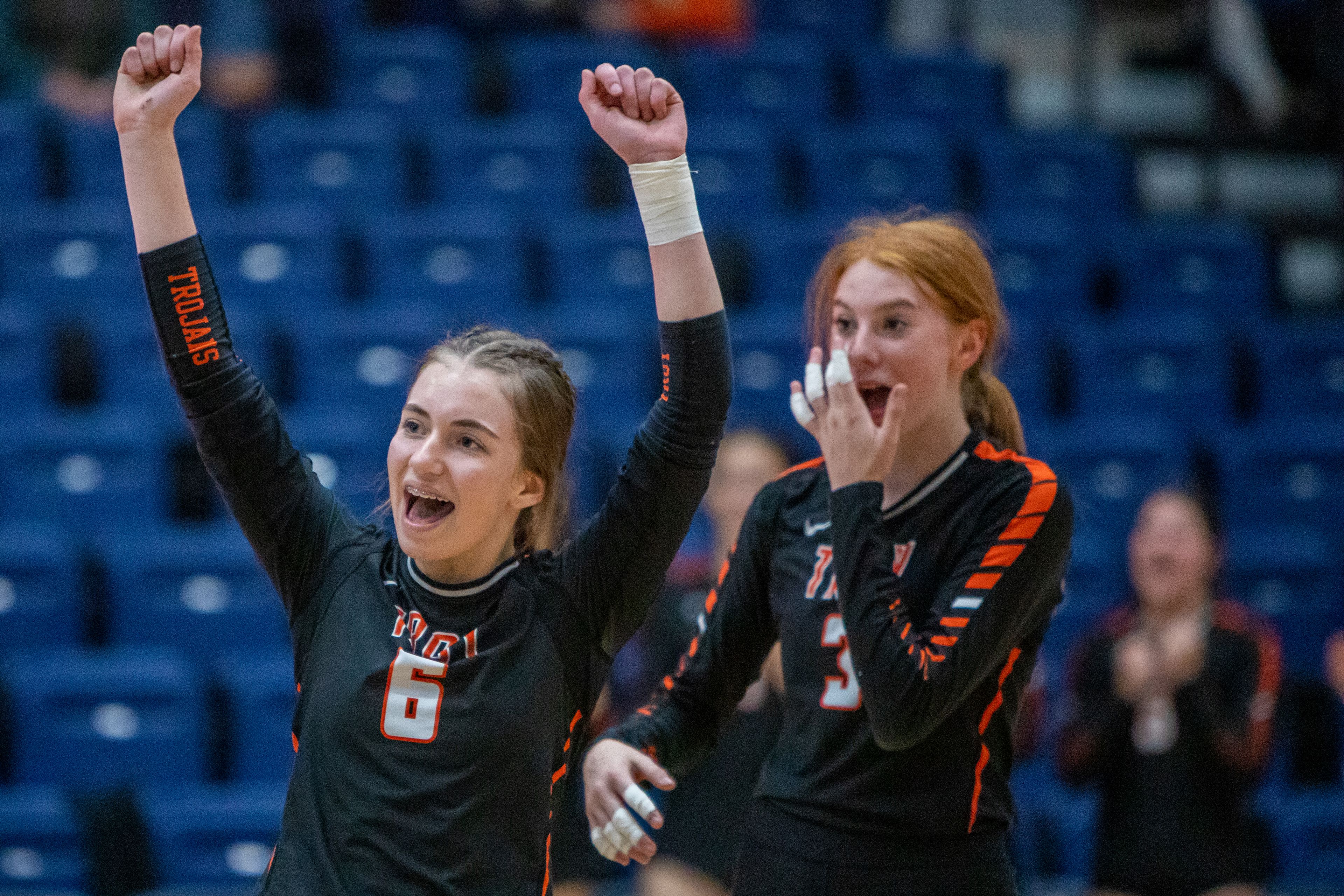 Troy High libero Laura House, left, and outside hitter Dericka Morgan celebrate their team scoring a point against Genesee High during the Idaho Class 1A Division I district volleyball tournament at the P1FCU Activity Center in Lewiston on Wednesday.