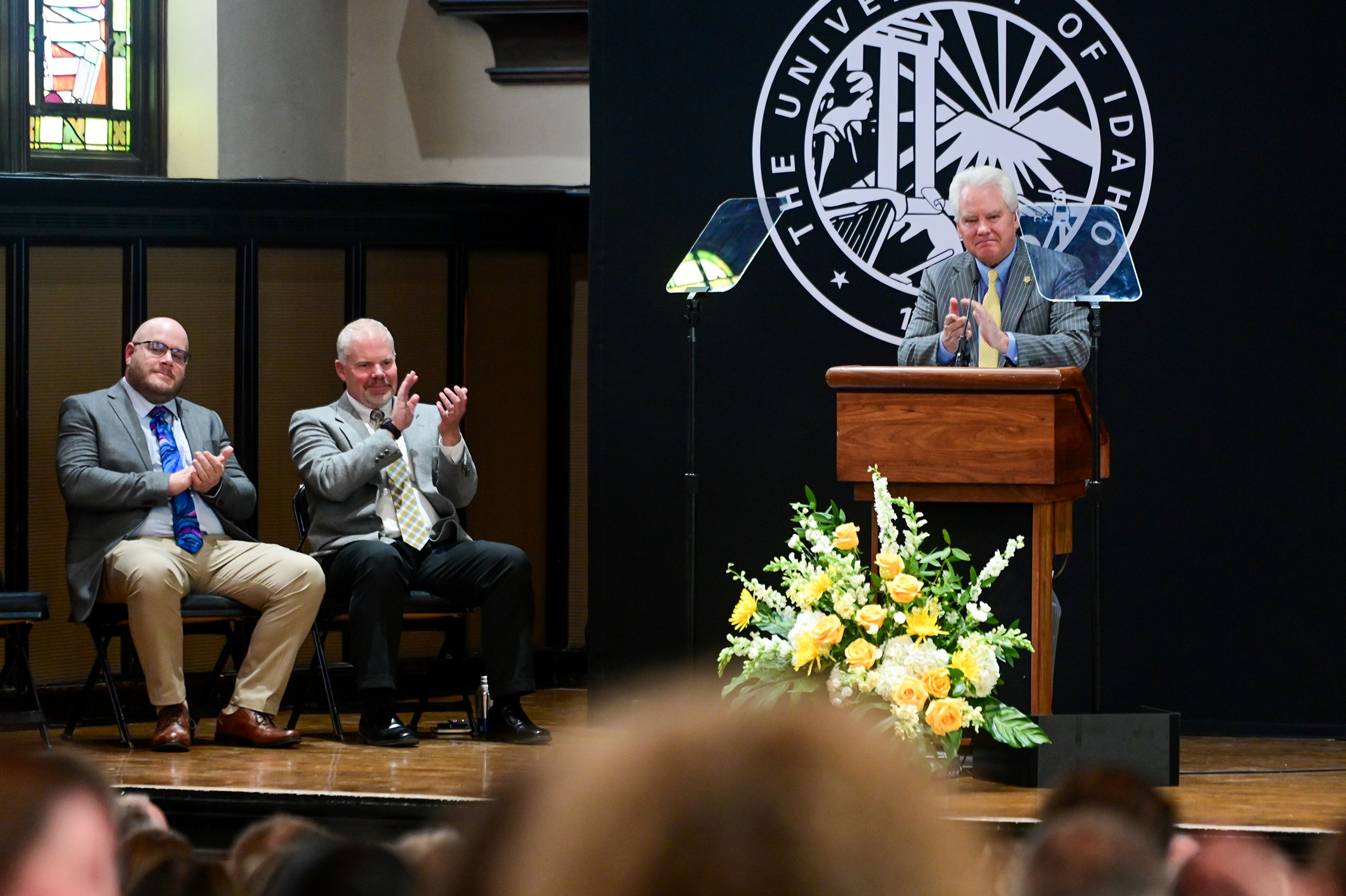 University of Idaho President C. Scott Green, right, applauds for a staff member in the audience during the state of the university address on Tuesday in Moscow.