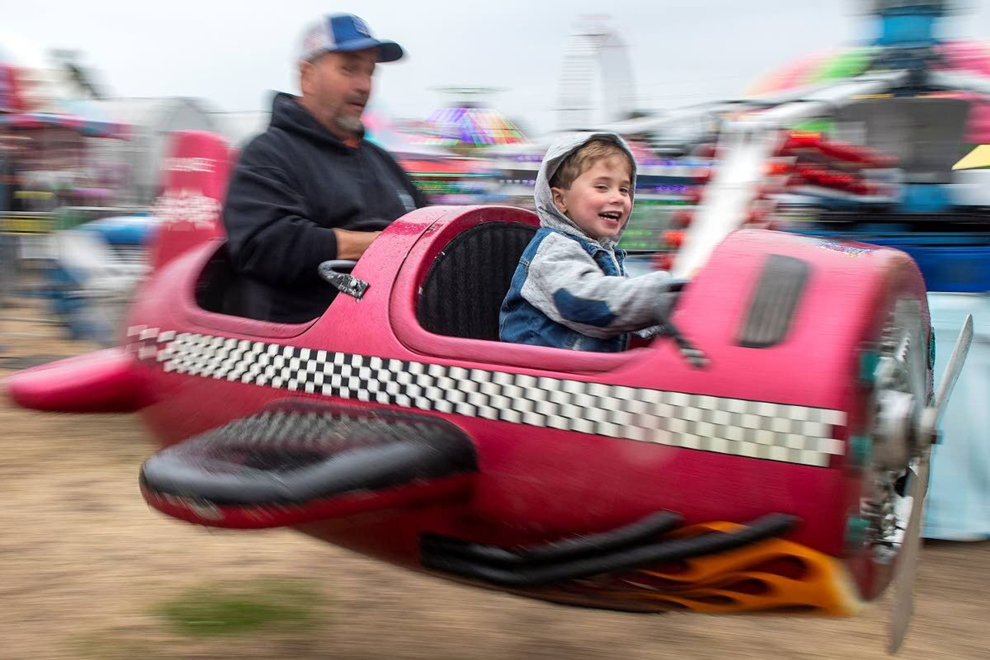 Zachariah Haskell, 4, of Moscow, rides the Dive Bomber attraction with his father Danny as his co-pilot Saturday morning at the Latah County Fair in Moscow.