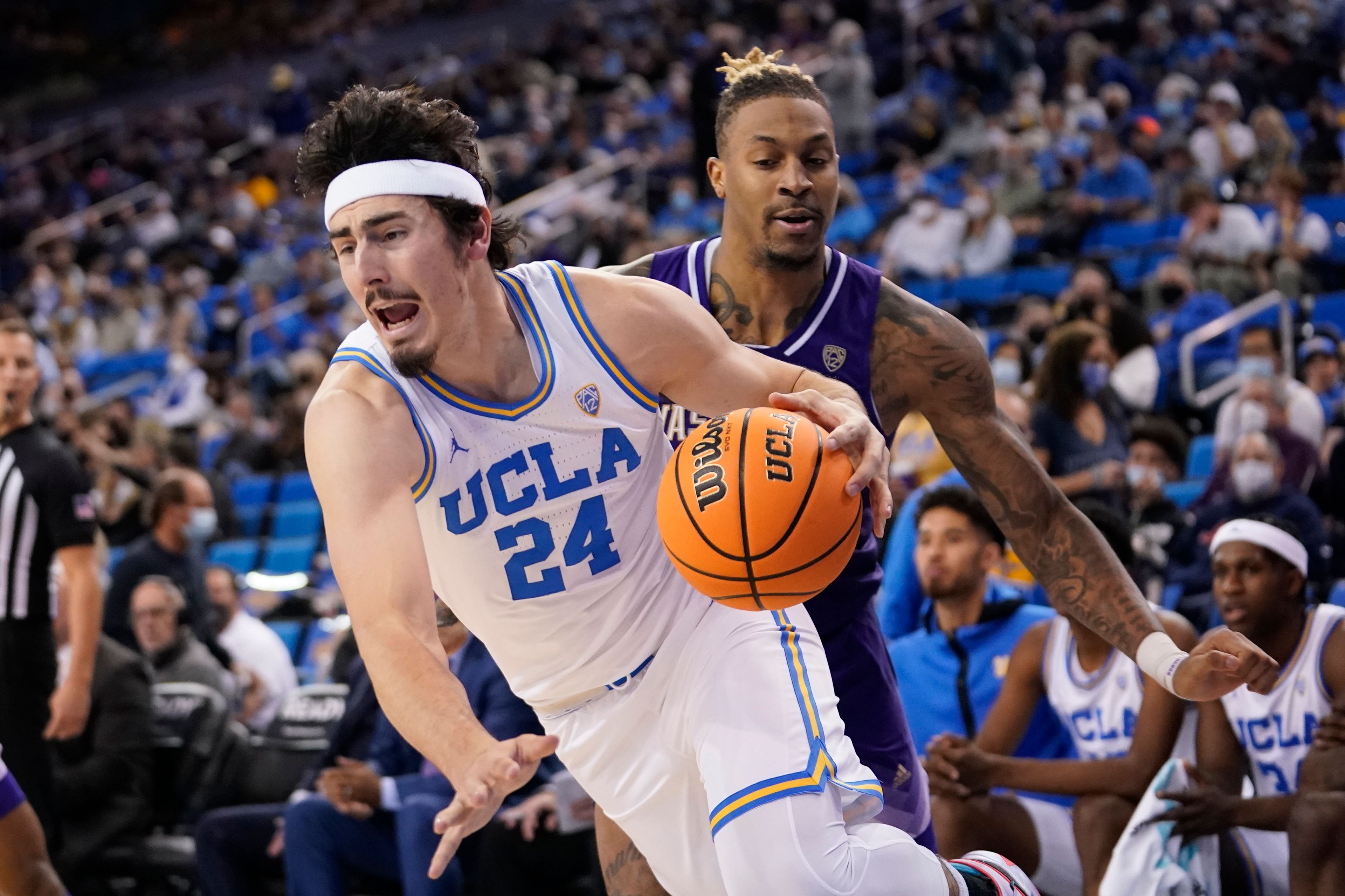 FILE - UCLA's Jaime Jaquez Jr. (24) dribbles against Washington during the second half of an NCAA college basketball game Feb. 19, 2022, in Los Angeles. UCLA returns forward Jaquez and point guard Tyger Campbell, two of the Pac-12's best players the past three seasons. The crafty Jaquez is healthy again after dealing with an ankle injury last season. (AP Photo/Marcio Jose Sanchez, File)