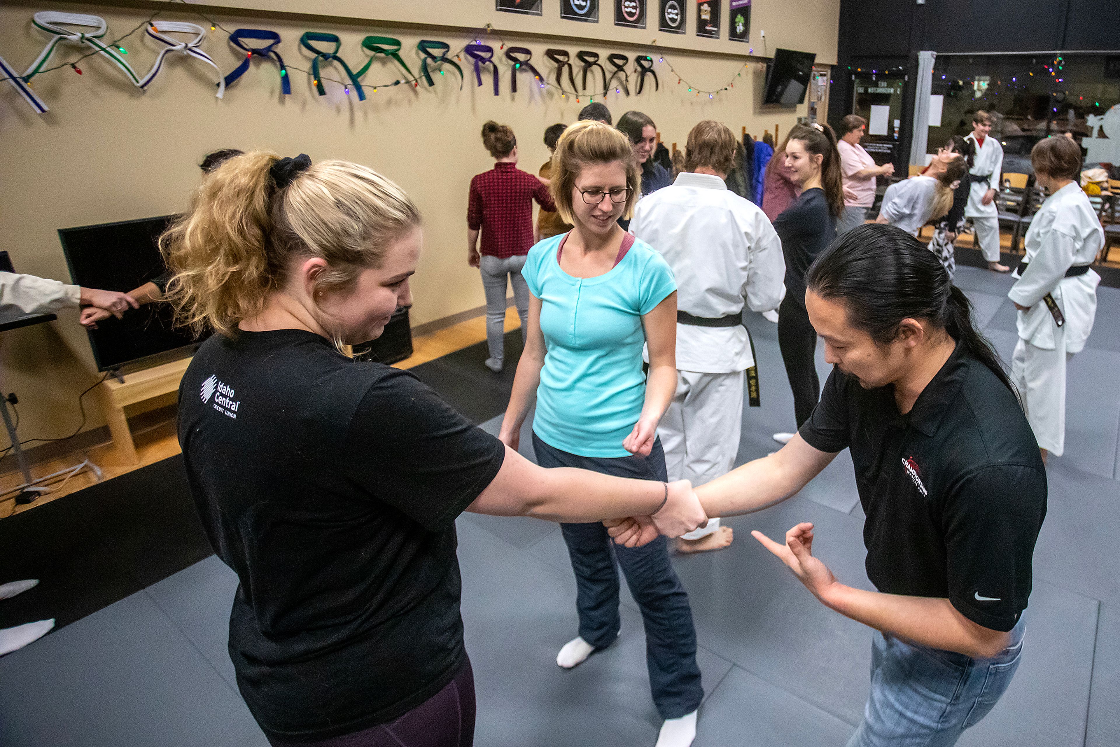 Chris Schwartz demonstrates for Hanna Heath, left, and Lucy Butler, both of Moscow, how to roll away if someone grabs their wrist during his self-defense class at Northwest Wado-ryu karate Thursday last week in Moscow.