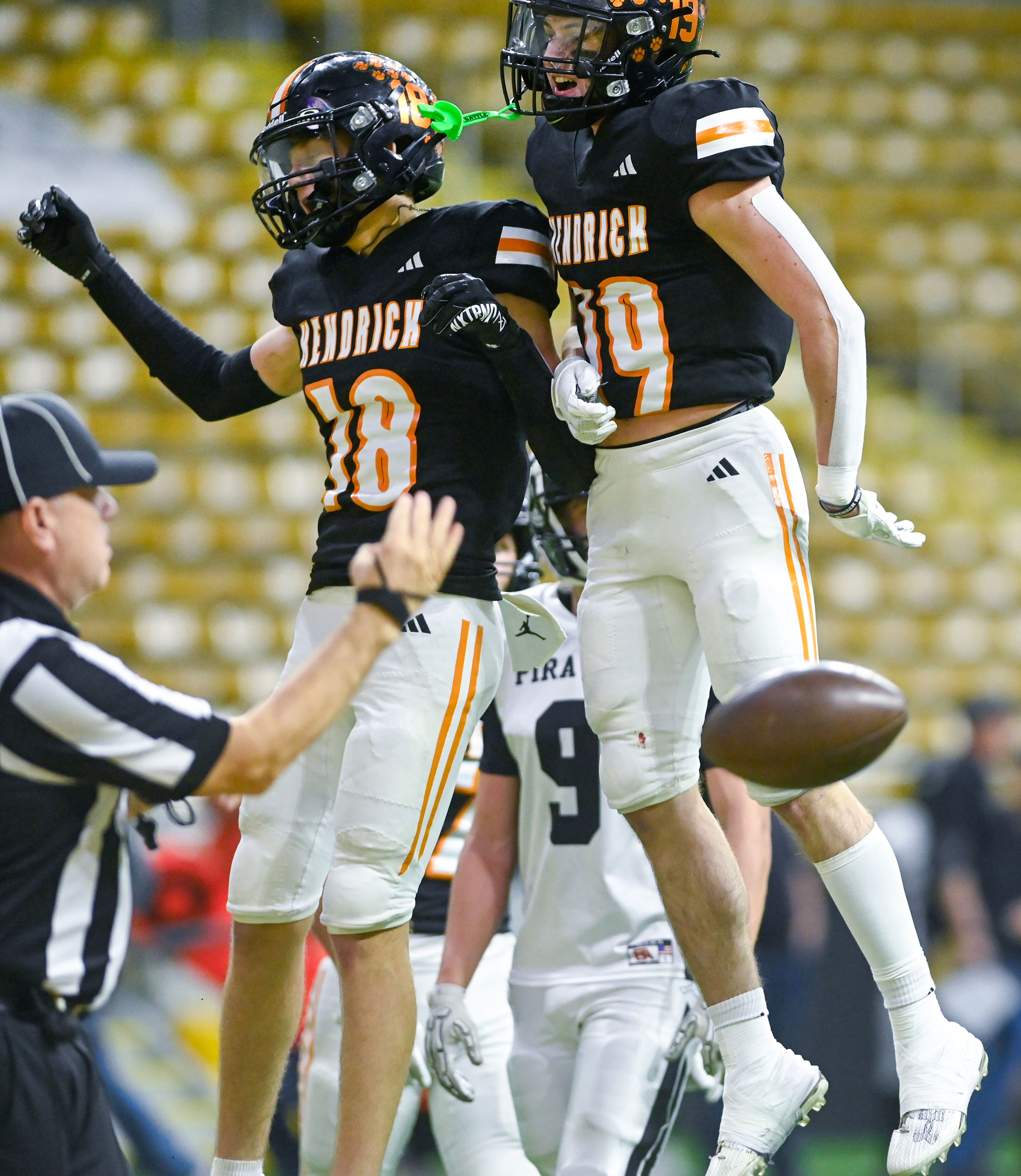 Kendrick’s Cade Silflow, left, and Sawyer Hewett jump to celebrate Silflow’s touchdown against Butte County Friday during the Idaho 2A football state championship game at the P1FCU Kibbie Dome in Moscow.