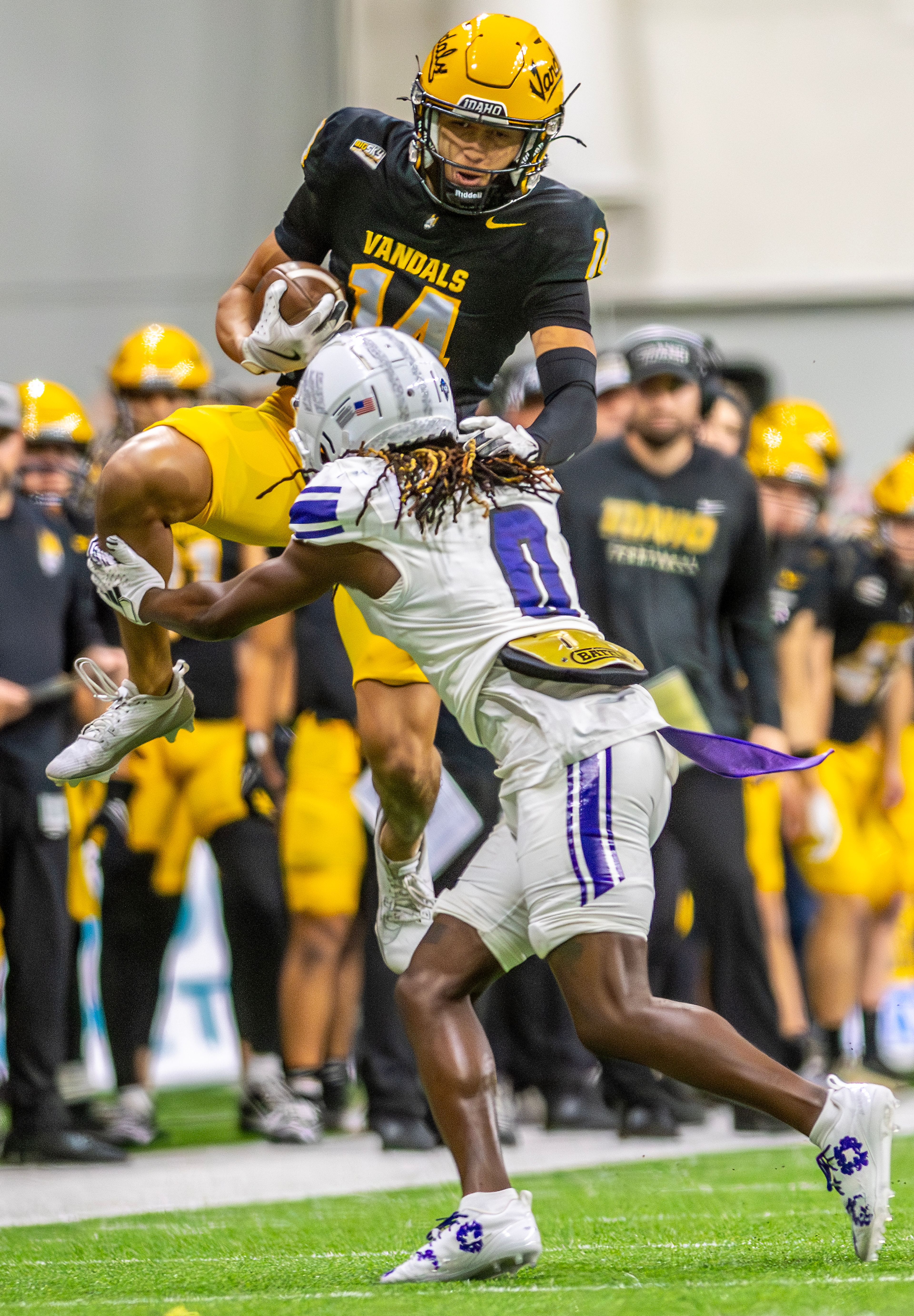 Idaho wide receiver Emmerson Cortez-Menjivar leaps into the air as Weber State cornerback Jalon Rock tackles him during a quarter of a Big Sky conference game Saturday at the P1FCU Kibbie Dome in Moscow.