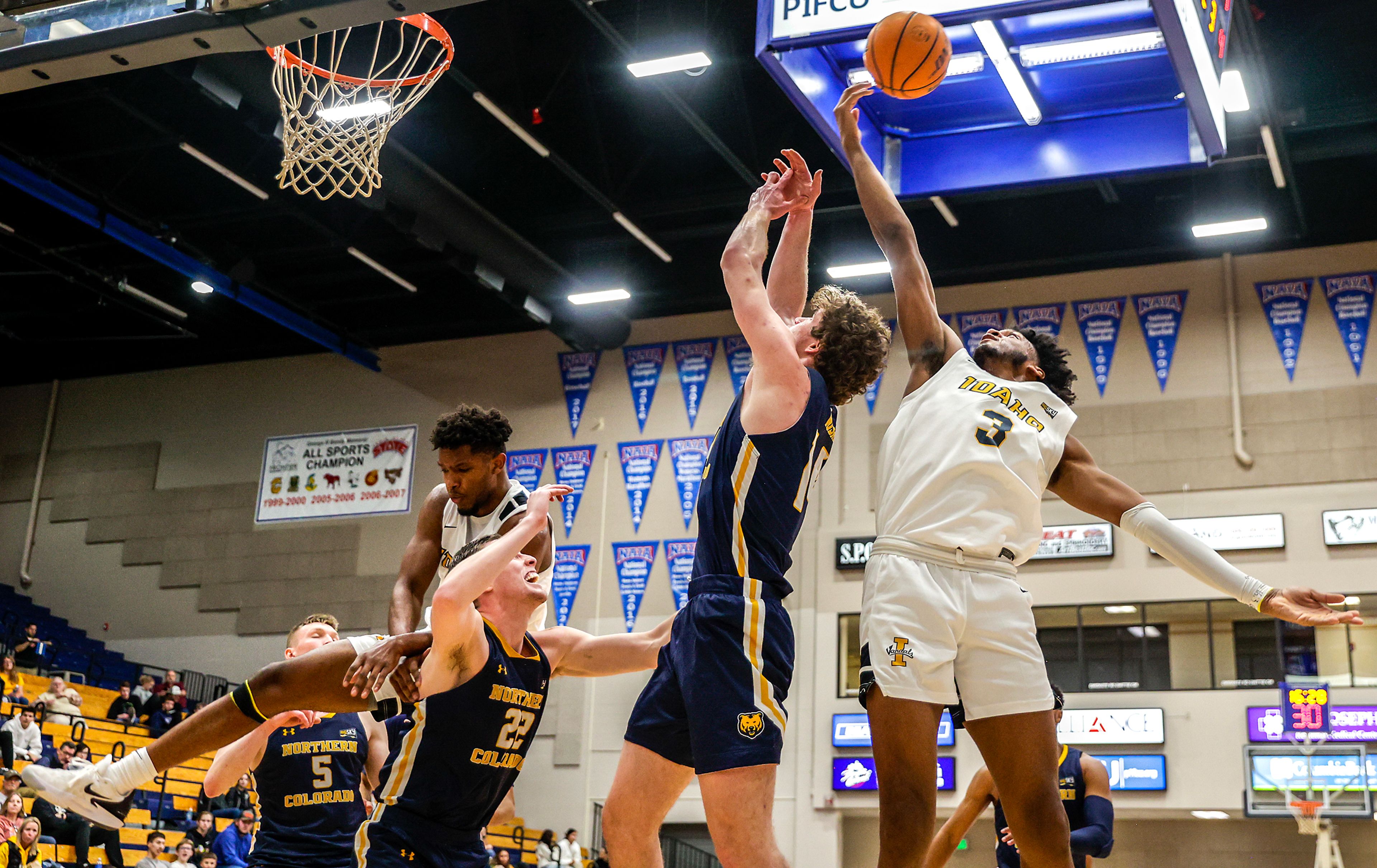 Idaho forward/center Isaac Jones reaches up to tip the rebound away from Northern Colorado forward Brock Wisne in a Big Sky game at the P1FCU Activity Center on the Lewis-Clark State College campus Thursday in Lewiston.