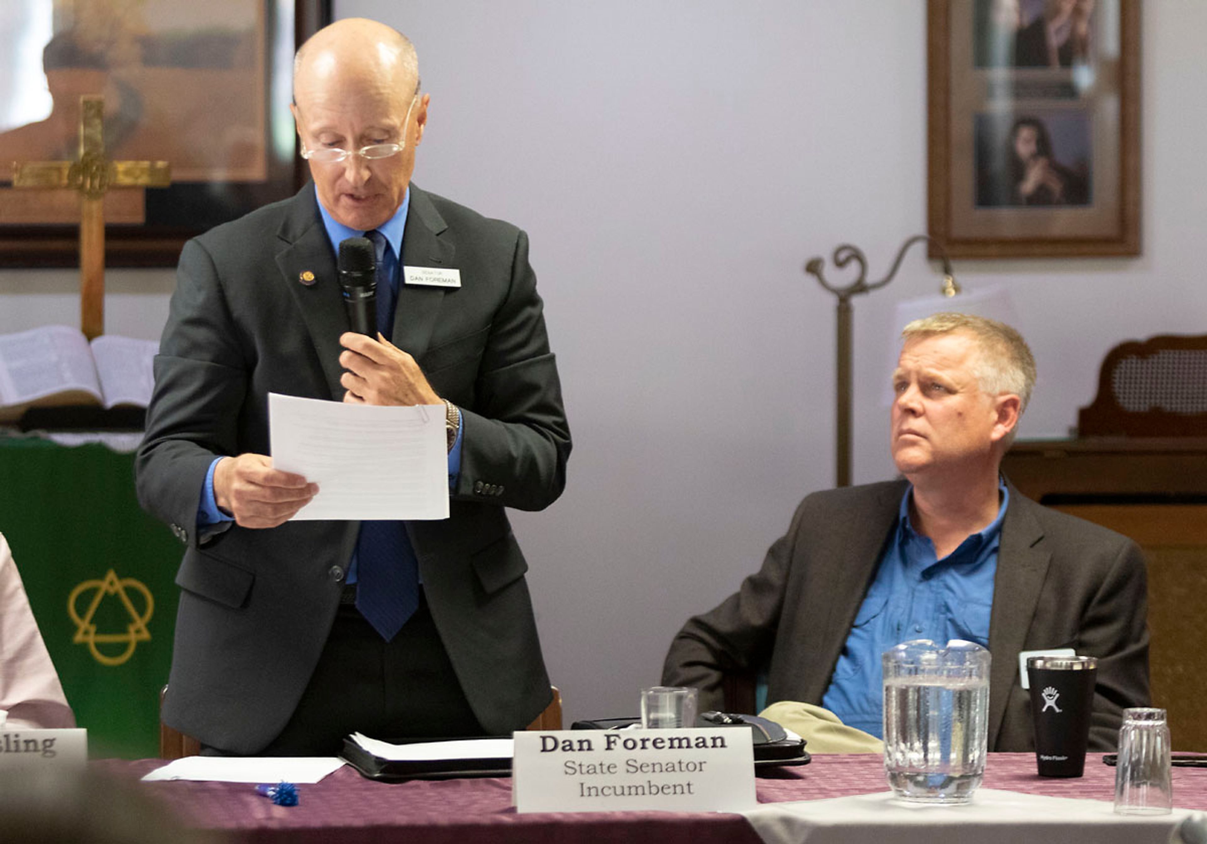 David Nelson, right, listen while Dan Foreman speaks during a forum for Idaho legislative candidates October in Moscow.