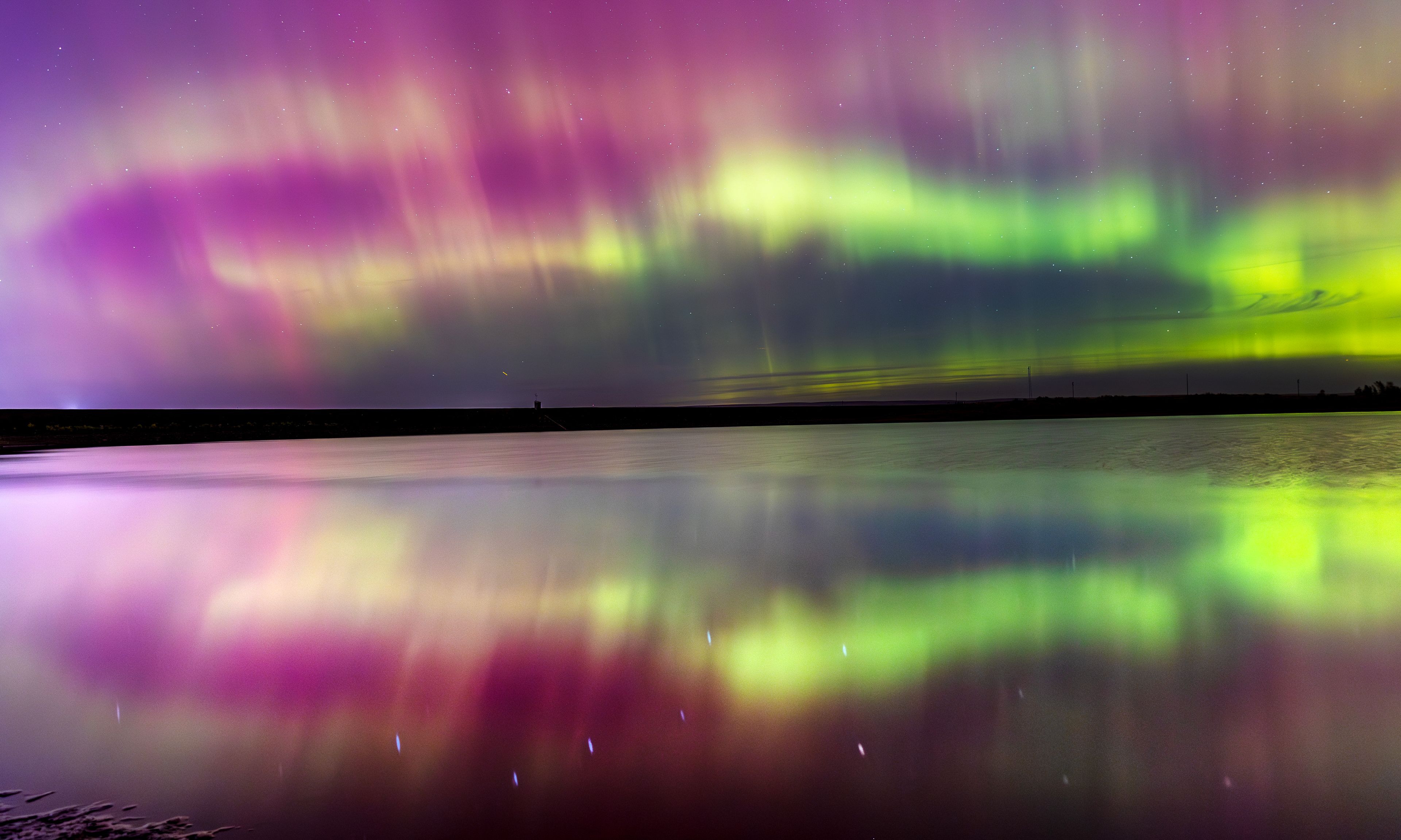 The aurora borealis lights the sky north of Mann Lake Thursday in Lewiston. The light show was caused by a geomagnetic storm resulting from Earth being struck by charged particles, also known as plasma, that burst out from sunspot AR 3848 according to the National Oceanic and Atmospheric Administration. The plasma eruption is an example of coronal mass ejection which traveled to Earth at 2.9 million mph. The most recent storm reached G4 levels, the second highest, on the NOAA Space Weather Prediction Center scales "We're in for a ride the rest of this year, all of next year and even into 2026 before things will start to work their way back down to solar minimum," Shawn Dahl, a forecast coordinator with the Space Weather Prediction Center, told CBS News.,