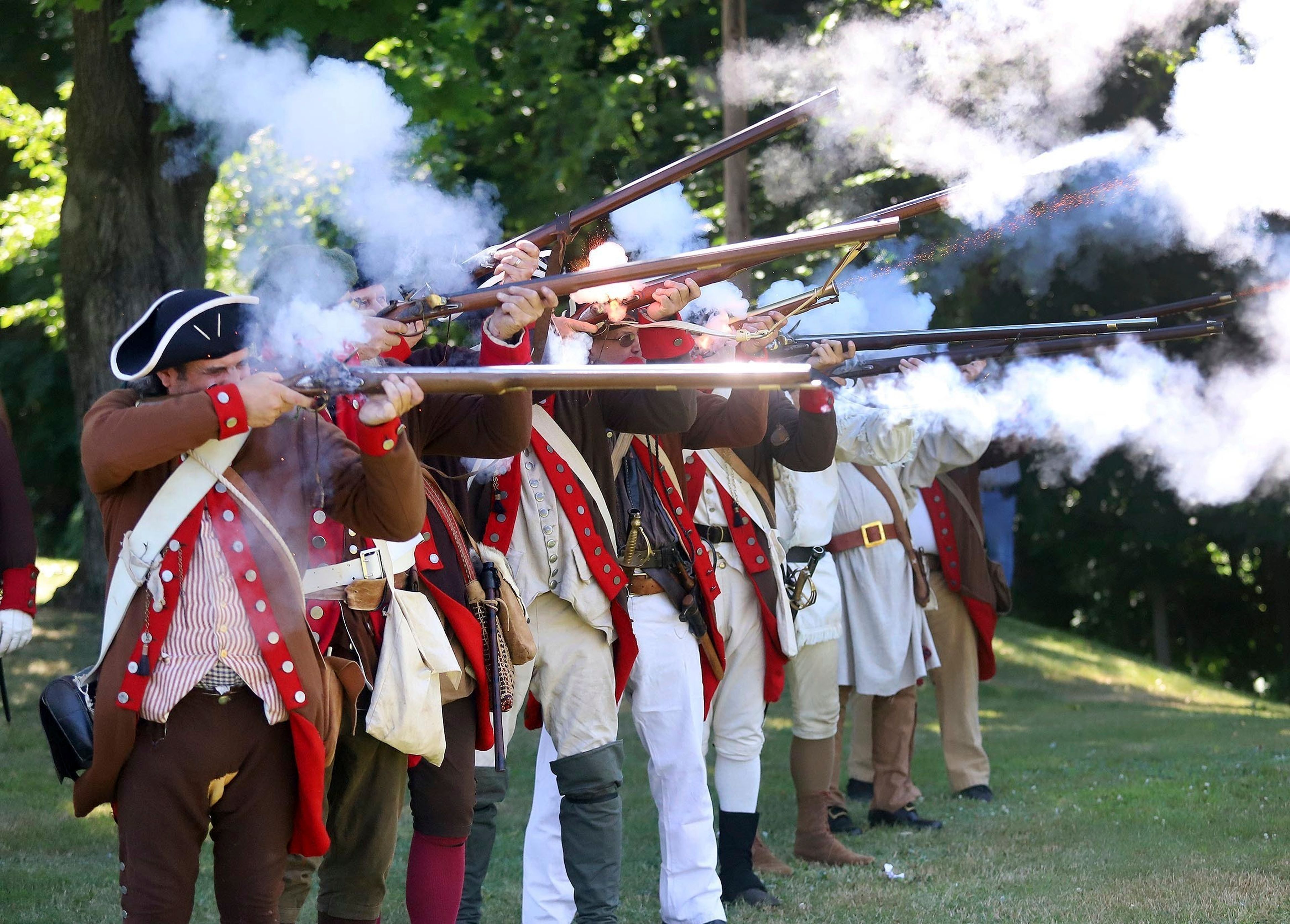 Members of the 24th Connecticut Militia fire a volley during the 144th annual Commemorative Service for the Battle and Massacre of Wyoming held on the grounds of the Wyoming Monument Monday, July 4, 2022, in Wyoming Pa. (Dave Scherbenco/The Citizens' Voice via AP)