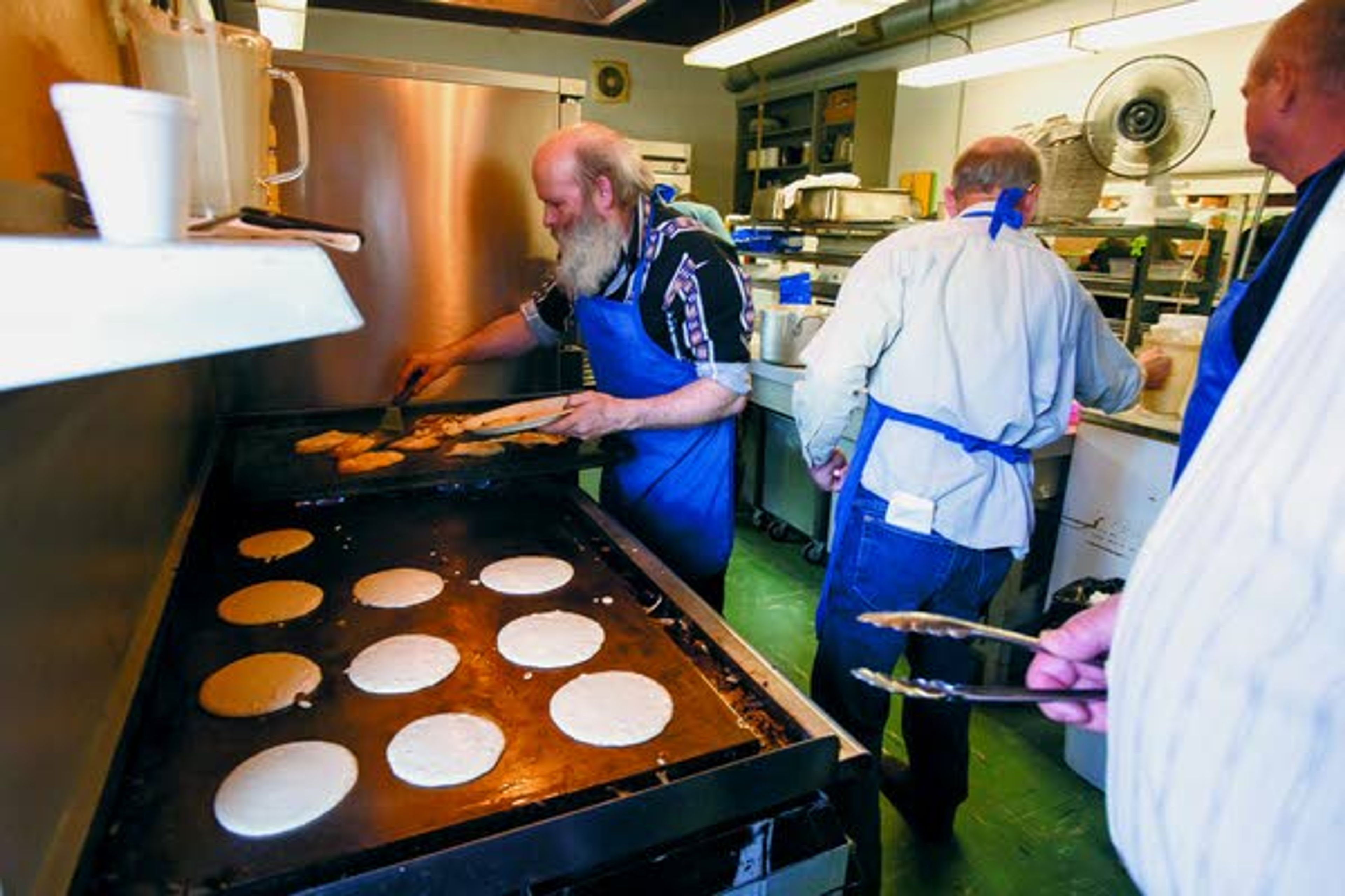 Dennis Frei, left, cooks fried eggs during the Potlatch Knights of Columbus Pancake and Sausage Feed on Sunday, March 16, 2014, at Potlatch Elementary School.