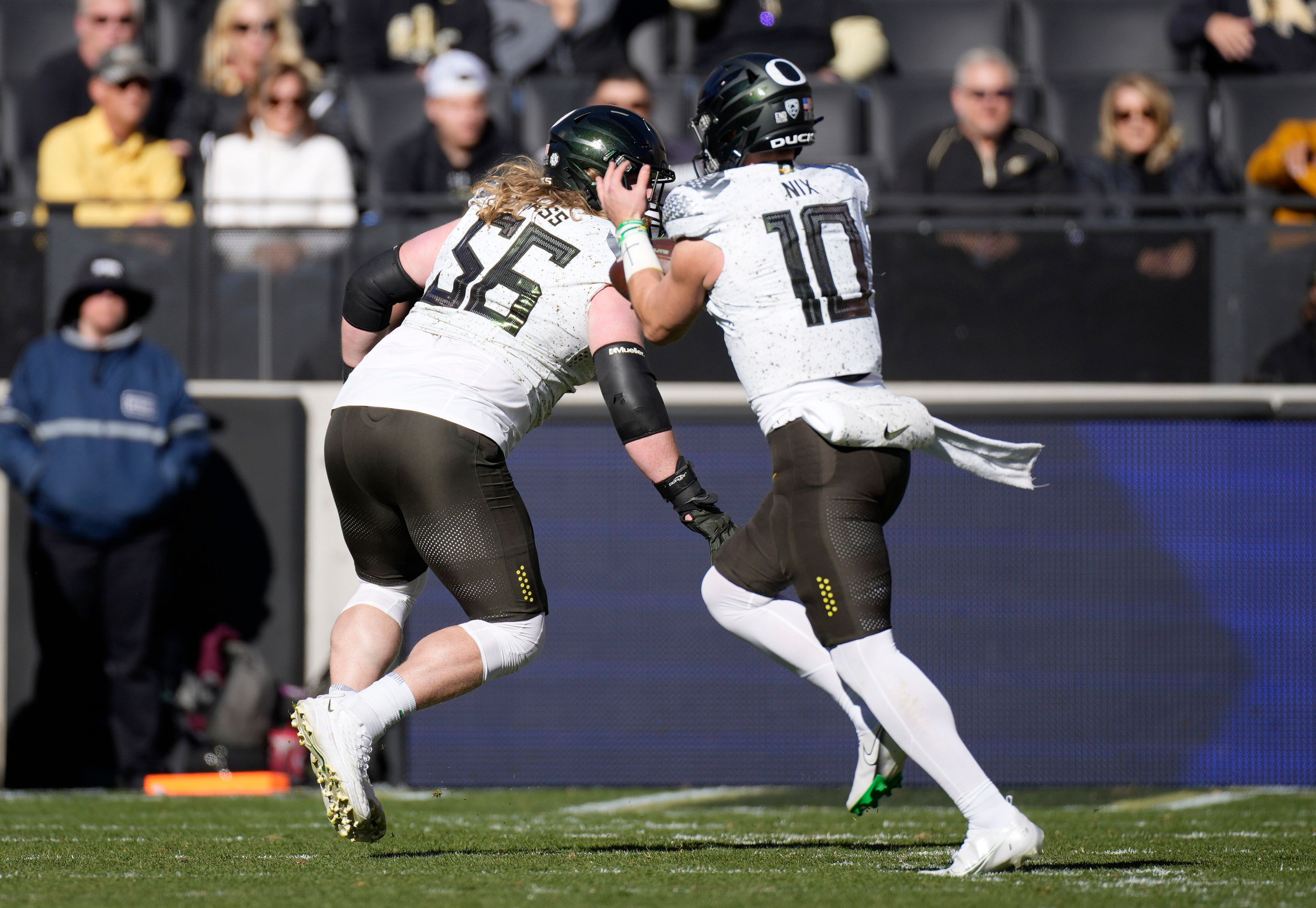 Oregon offensive lineman T.J. Bass, back, leads the way after quarterback Bo Nix caught a pass and runs for a touchdown against Colorado in the first half of an NCAA college football game, Saturday, Nov. 5, 2022, in Boulder, Colo. (AP Photo/David Zalubowski)