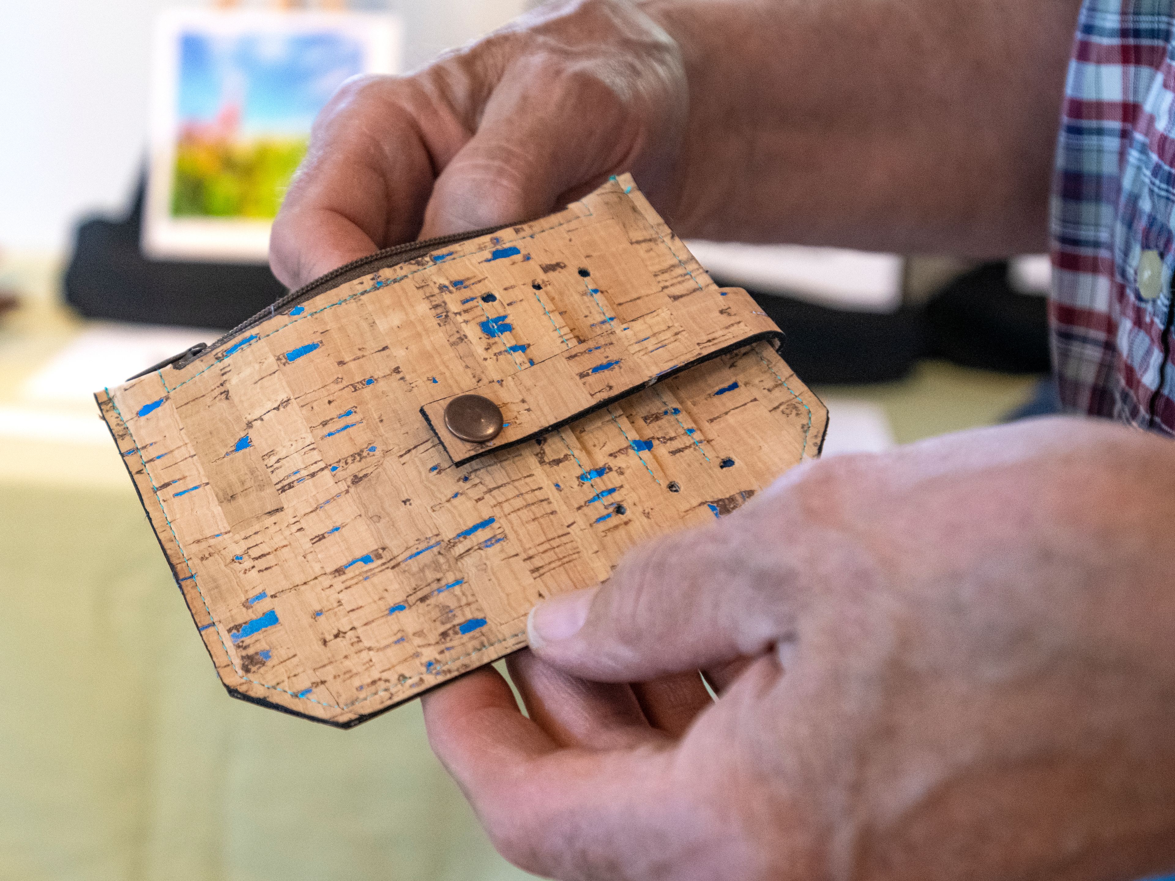 Erin Talbott, of Palouse, inspects the craftsmanship of Kathleen Williams’ cork fabric “Pocket Pal” at the Palouse Community Center for the 17th Annual Palouse ArtWalk