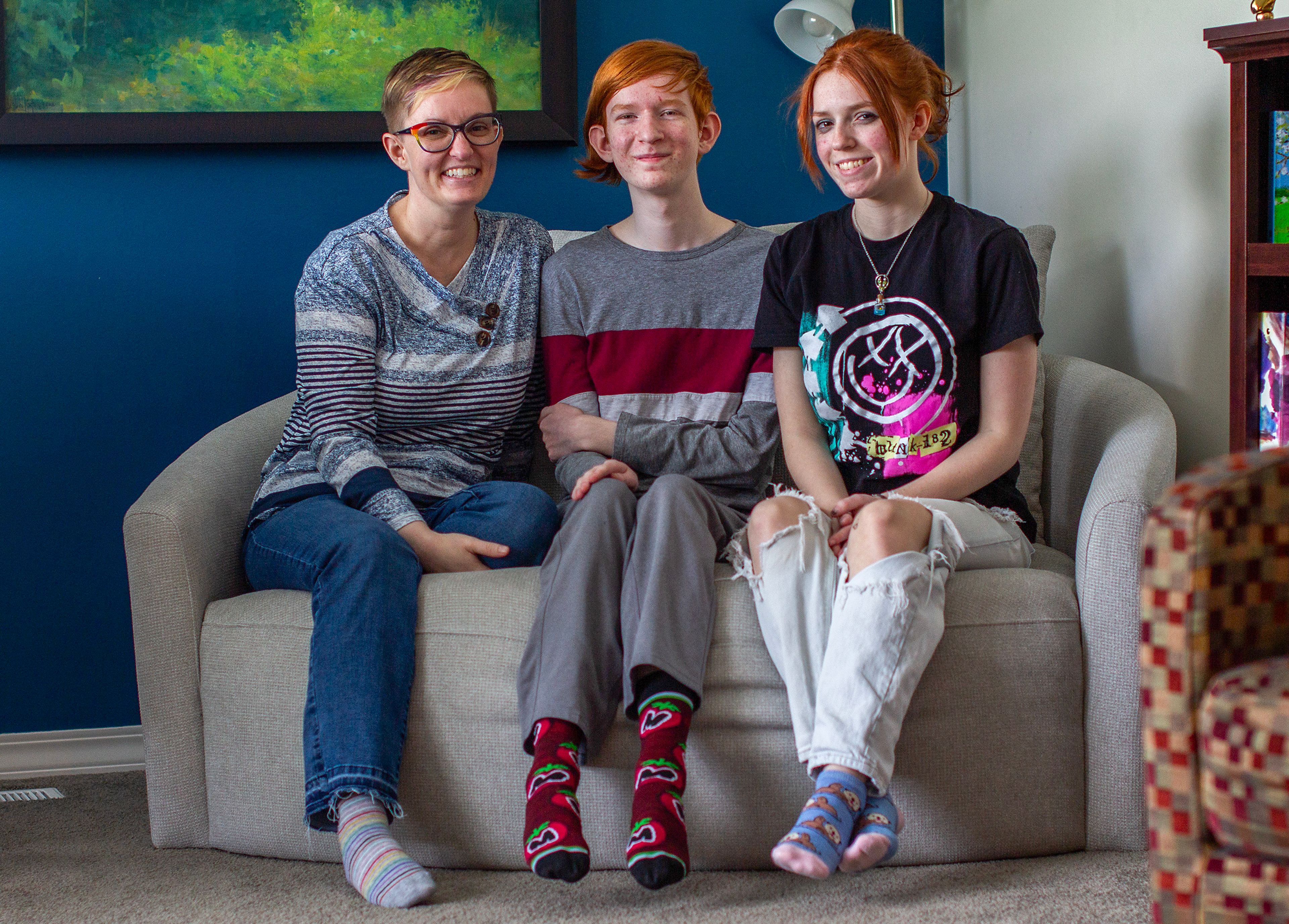 Jade Stellmon, sits with her kids, Hamilton Stellmon, 14, middle, and Tk Stellmon, 16, for a photo.