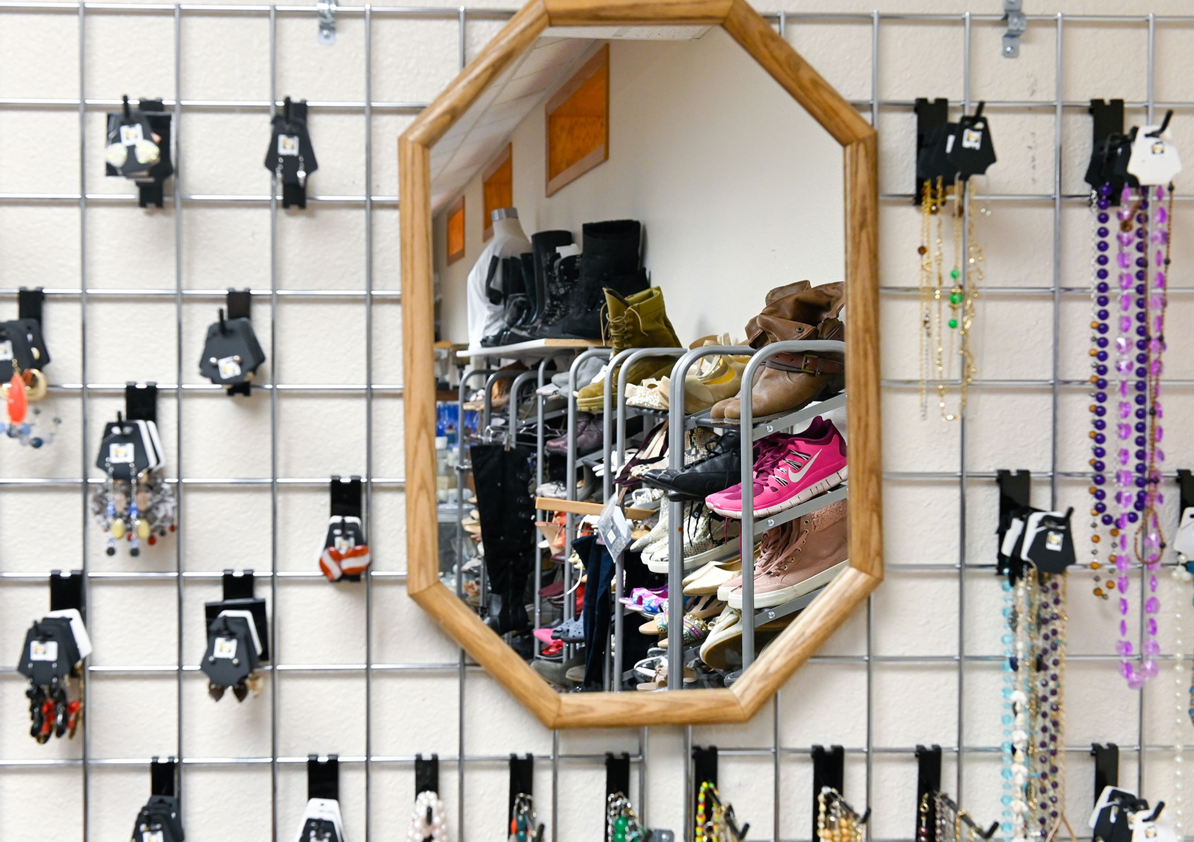 Racks of shoes are reflected in a mirror hanging in the center of a jewelry display of Cooper’s Legacy Foundation Resale Shop Wednesday in Pullman.