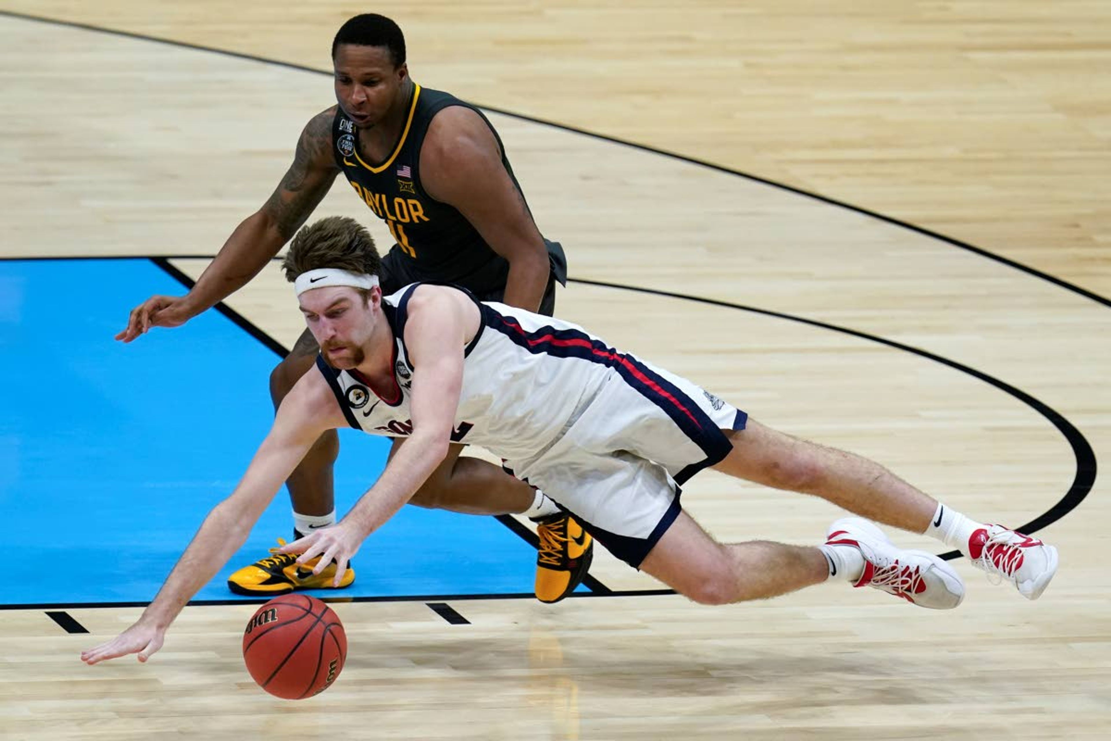 Gonzaga forward Drew Timme loses control of the ball ahead of Baylor guard Mark Vital, rear, during the second half of the championship game in the men's Final Four NCAA college basketball tournament, Monday, April 5, 2021, at Lucas Oil Stadium in Indianapolis. (AP Photo/Michael Conroy)