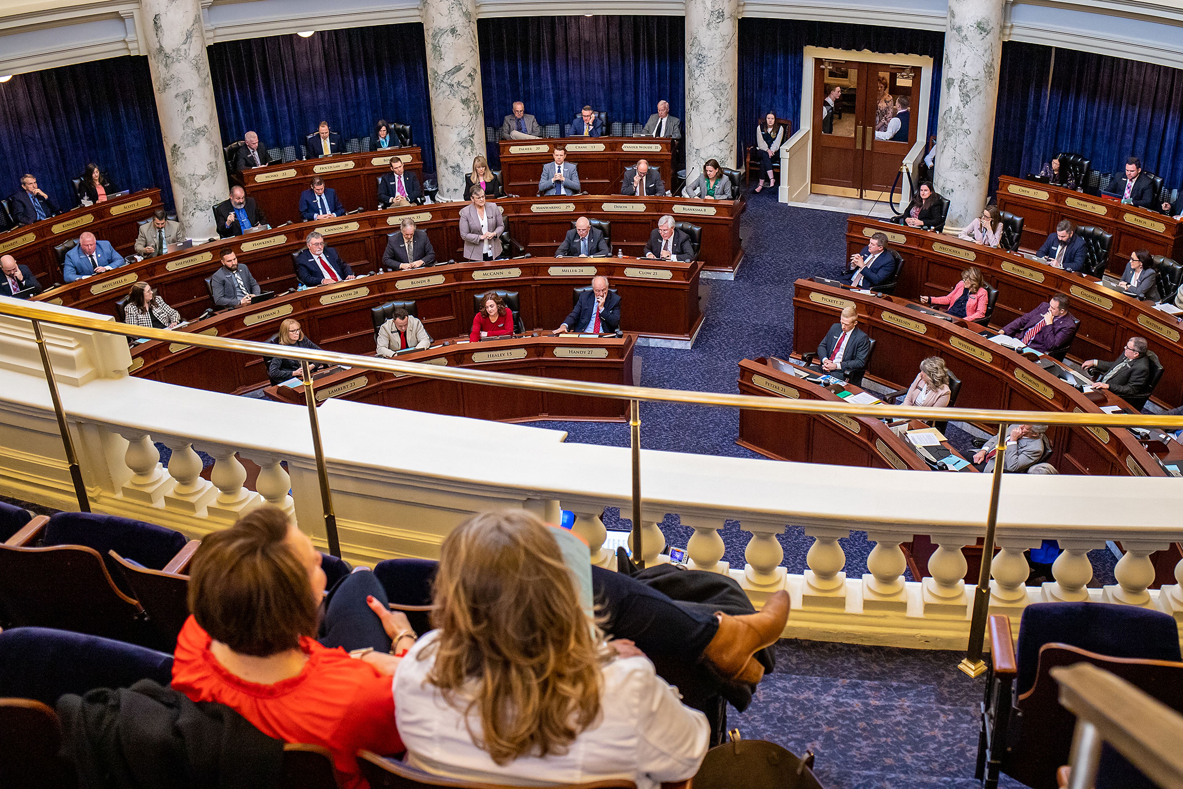 State Representative Lori McCann, standing, addresses the floor of the Idaho House of Representatives on Tuesday during a legislative season regarding a ban on transgender care for minors at the Capitol Building in Boise.