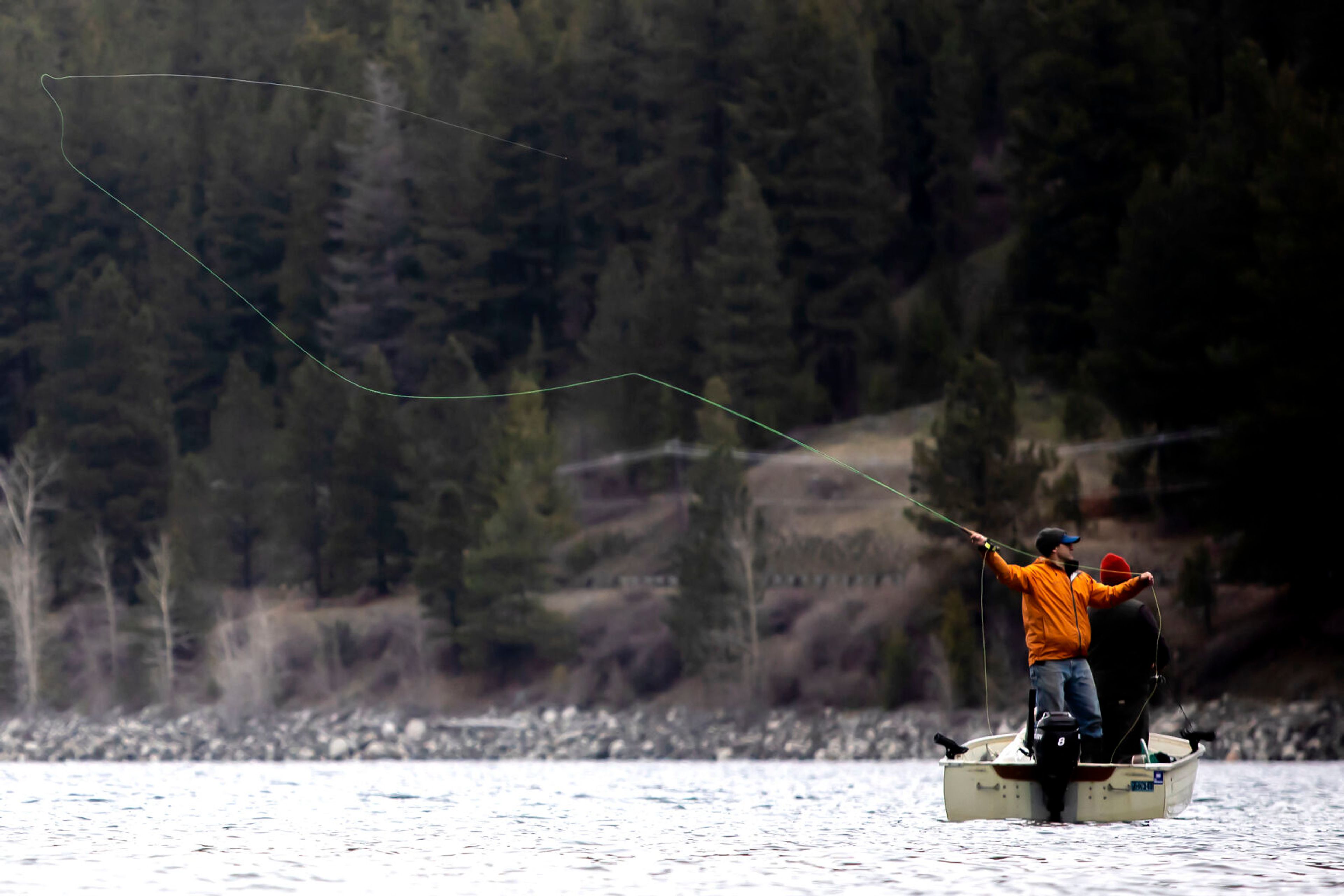 A fly fisher prepares to cast into Wallowa Lake outside Joseph, Ore.