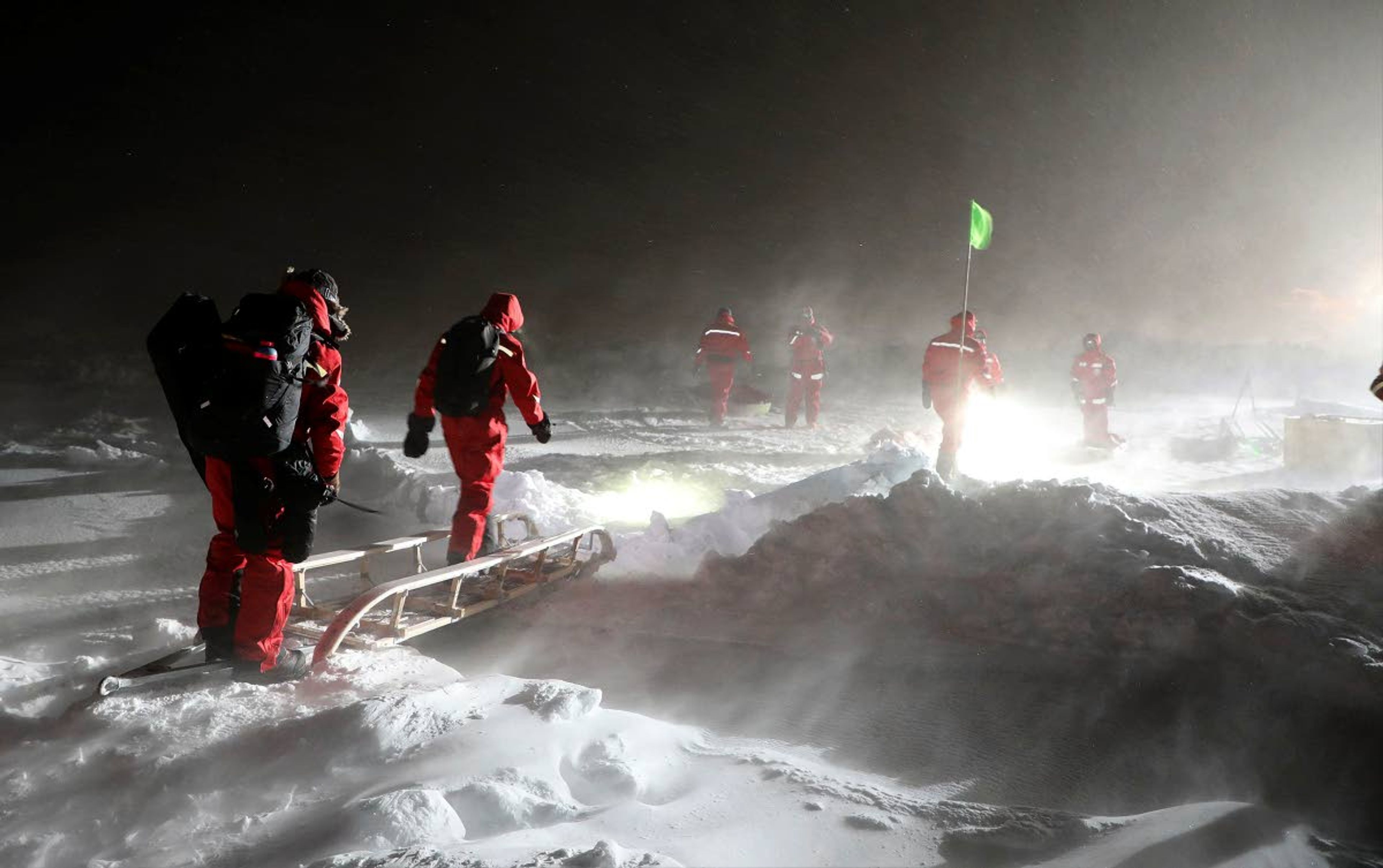 Scientists walk over a bridge during a storm outside the Polarstern. Shupe, co-coordinator of the MOSAiC expedition, helped coordinate the largest polar expedition in history to the Arctic Ocean.