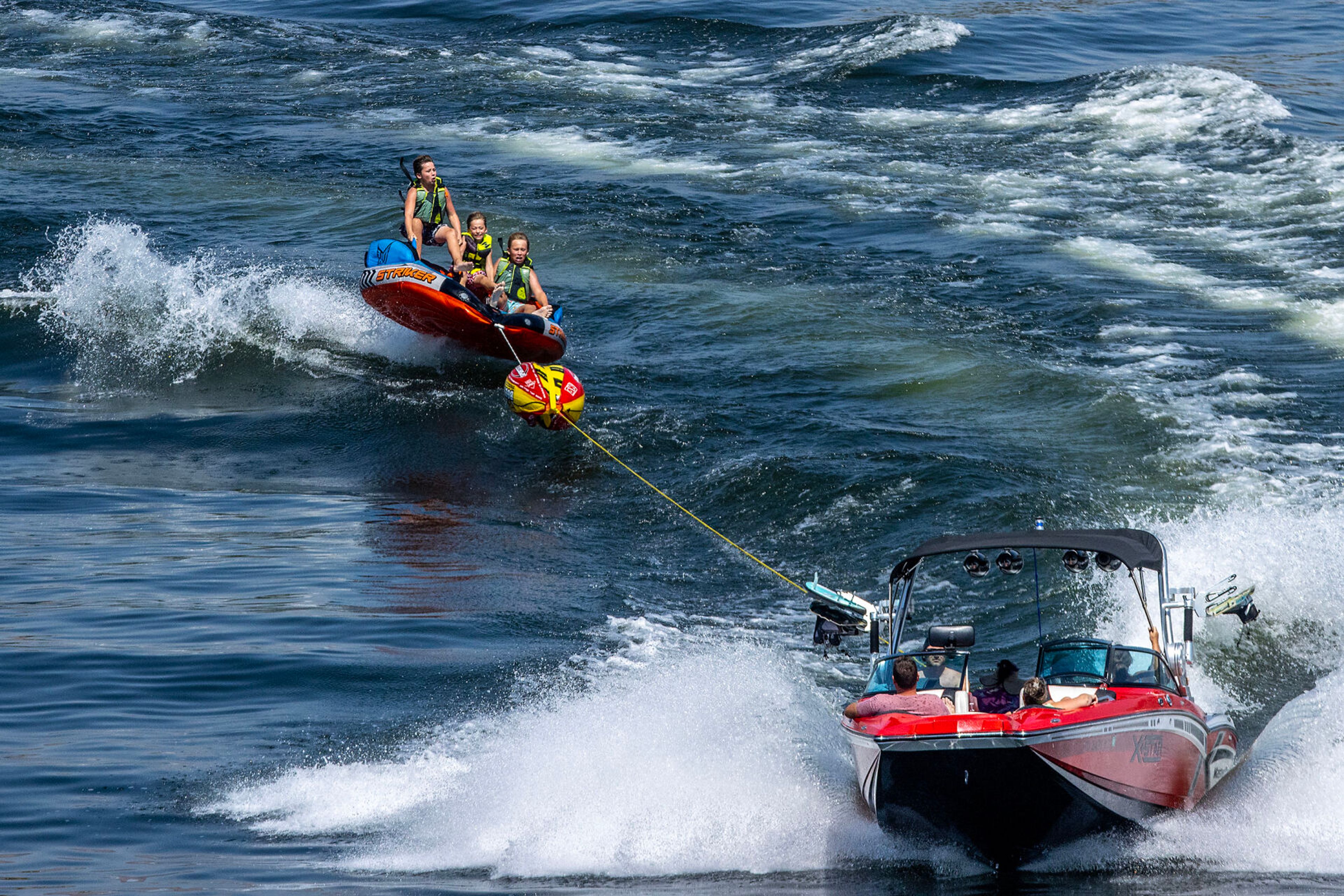 Kids are thrown upward as they are pulled behind a boat on Tuesday, Aug. 1, on the Snake River.