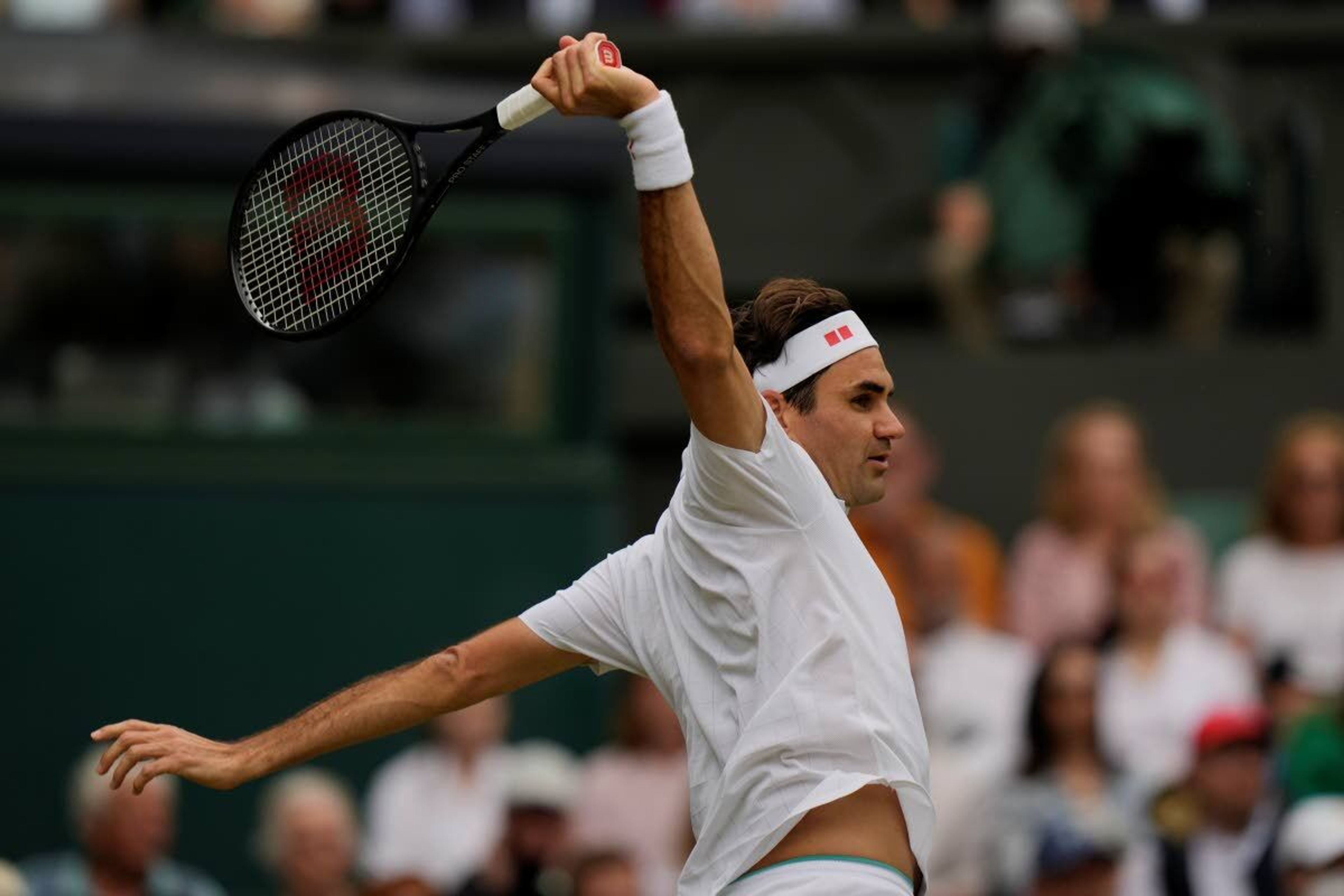 Switzerland's Roger Federer plays a return during the men's singles third round match against Britain's Cameron Norrie on day six of the Wimbledon Tennis Championships in London, Saturday July 3, 2021. (AP Photo/Alastair Grant)