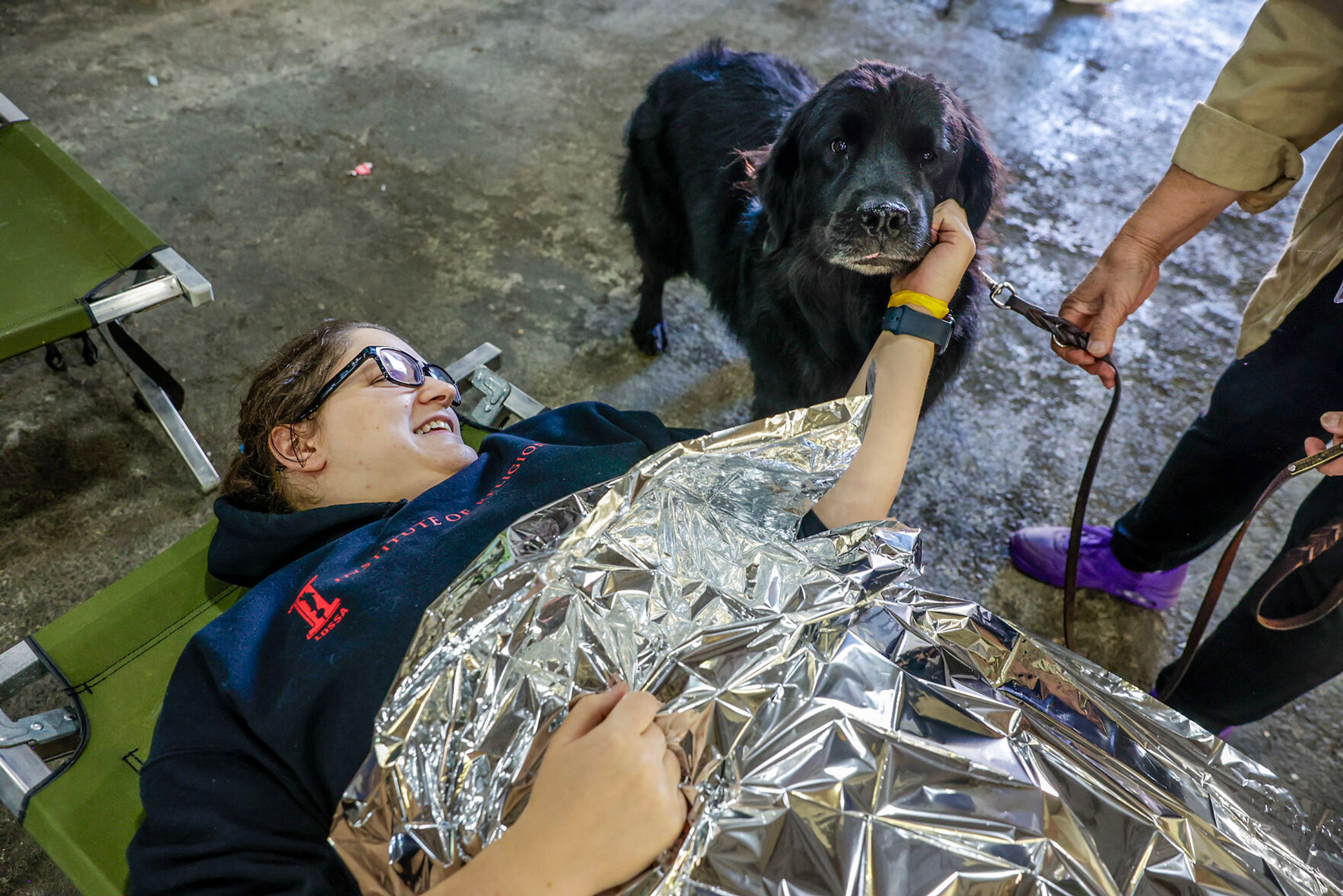 Krysten Stoker receives some emotional help from Lark during a disaster simulation of a windstorm Saturday at the Latah County Fairgrounds.