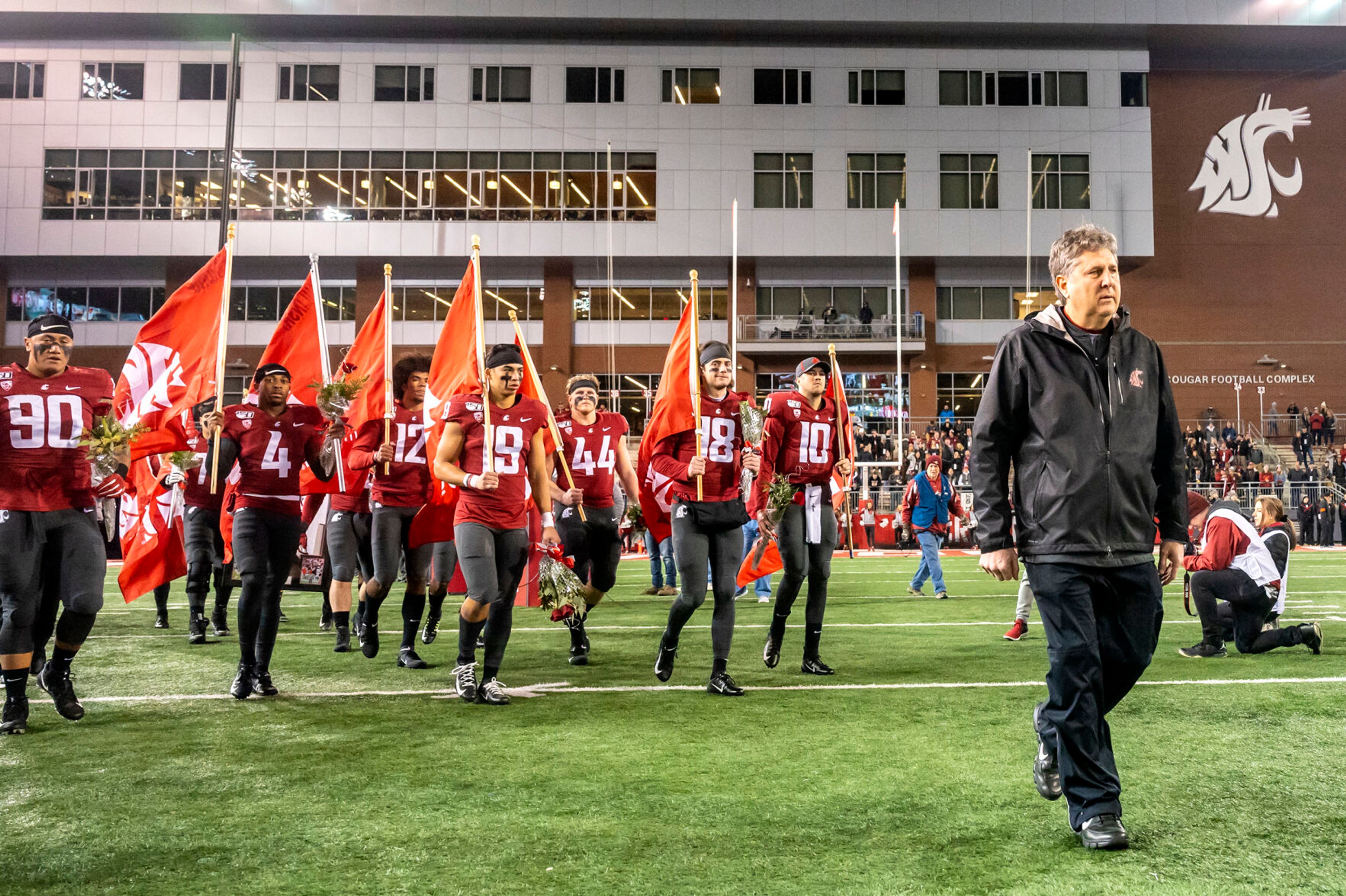 Former Washington State coach Mike Leach leads the senior class of Cougars out of the tunnel before the Nov. 23, 2019, Apple Cup game at then-Martin Stadium. This year’s team honored the coach, who died Monday because of a heart condition, with decals on the back of their helmets and carrying a pirate flag into SoFi Stadium on Saturday for the Jimmy Kimmel LA Bowl in Inglewood, Calif.