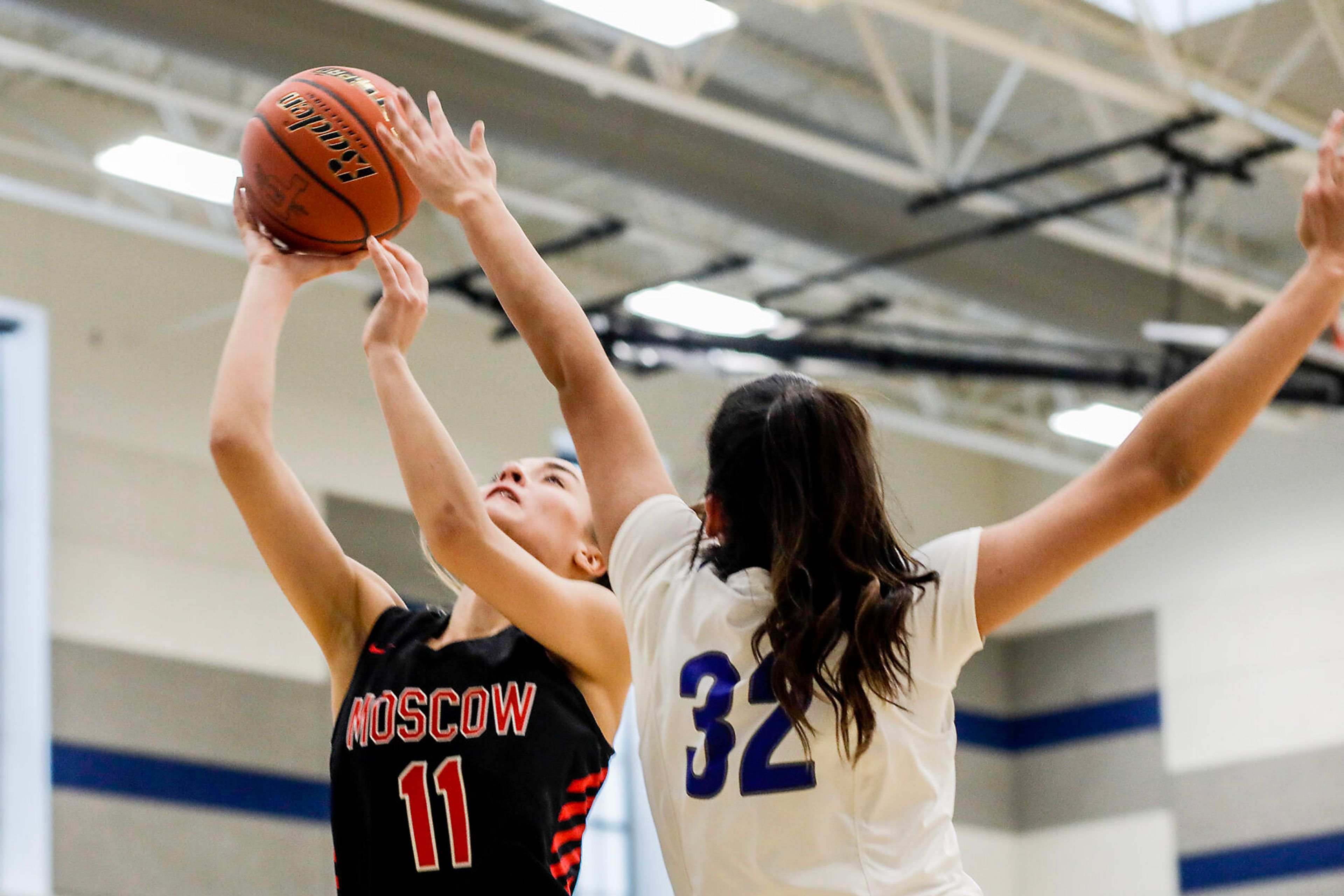 Moscow guard/forward Maya Anderson, left, goes up for a shot as Pullman post Sehra Singh defends during Saturday's nonleague girls basketball game.