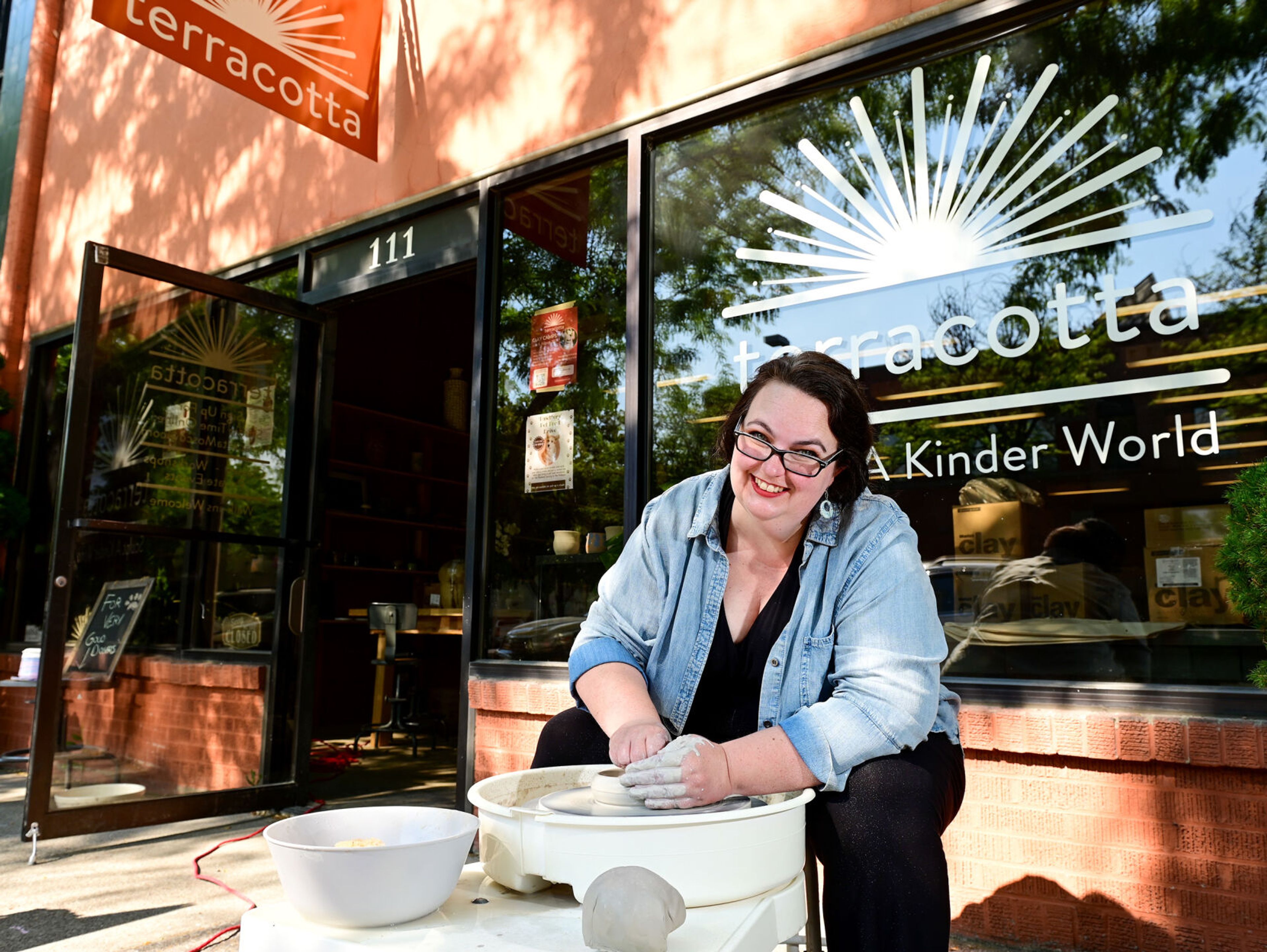 Owner and founder Candace Baltz sits at a potter's wheel outside of Terracotta’s new downtown Moscow space on Wednesday.