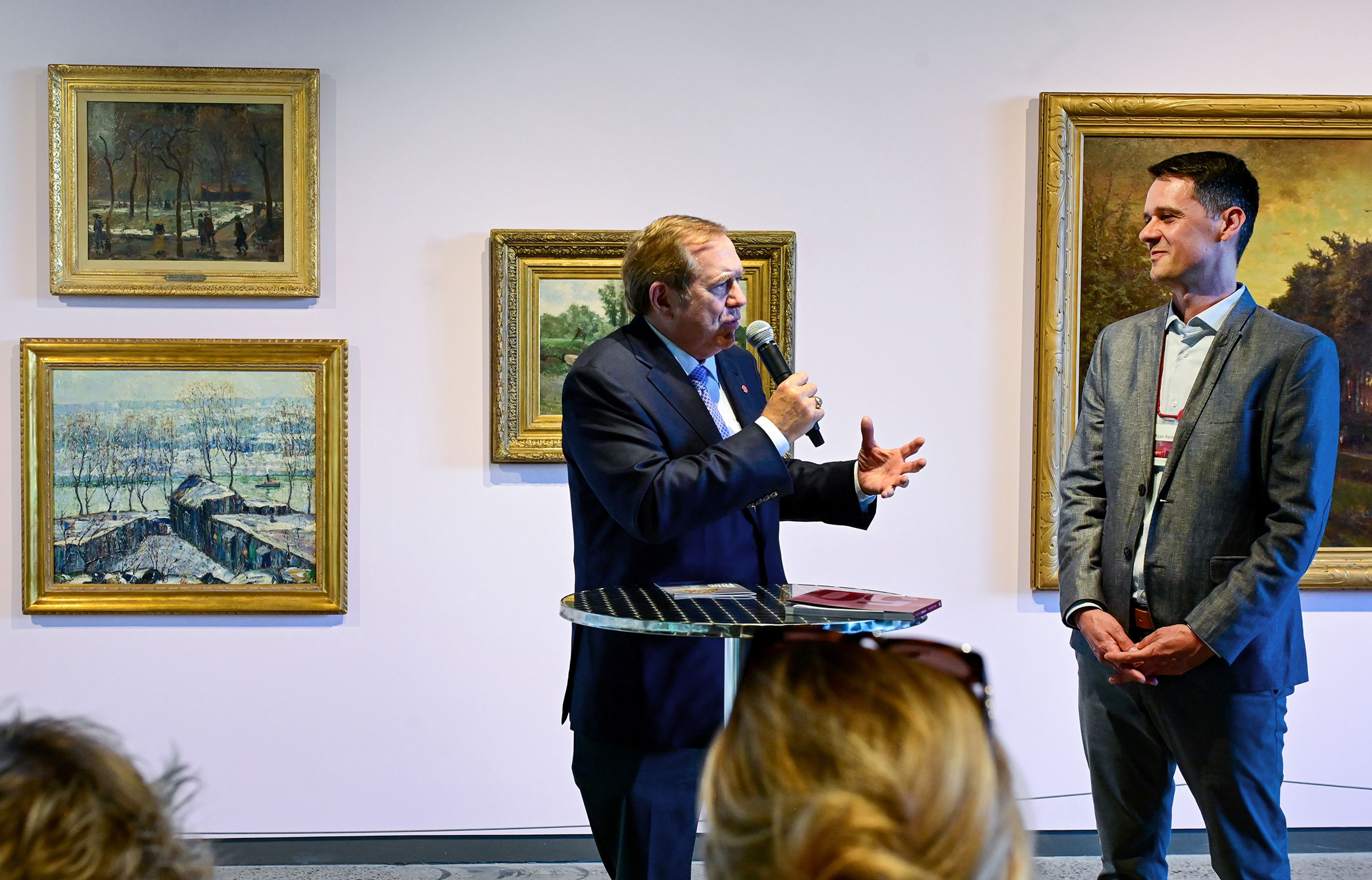 Jordan Schnitzer, left, founder of the Jordan Schnitzer Family Foundation, highlights Ryan Hardesty, right, executive director for the Jordan Schnitzer Museum of Art at Washington State University, during a reception and book release to celebrate the museums 50 year anniversary Thursday in Pullman.