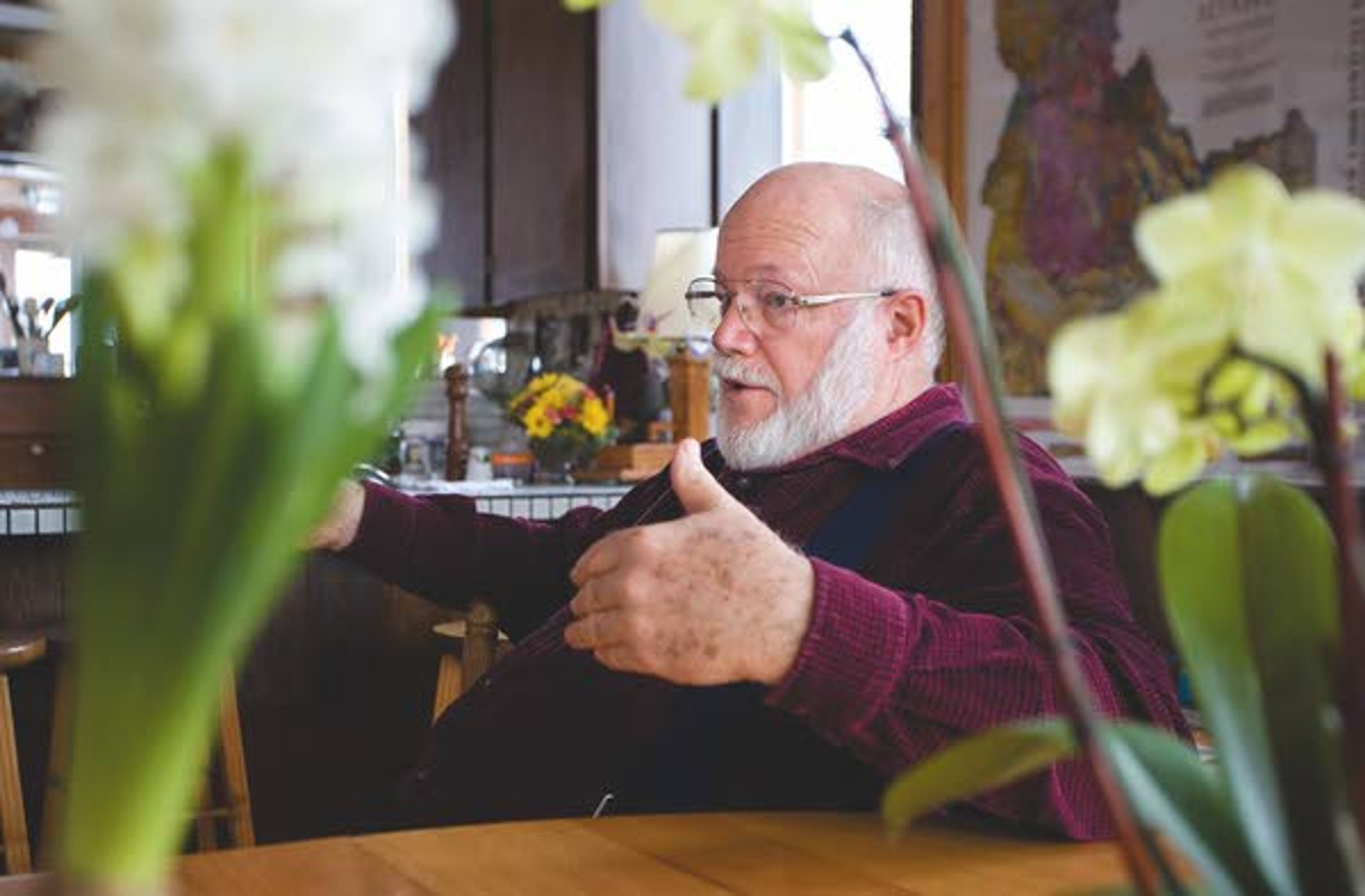 Gerry Queener talks about his passion for wildflower photography at his home in Troy on Friday.