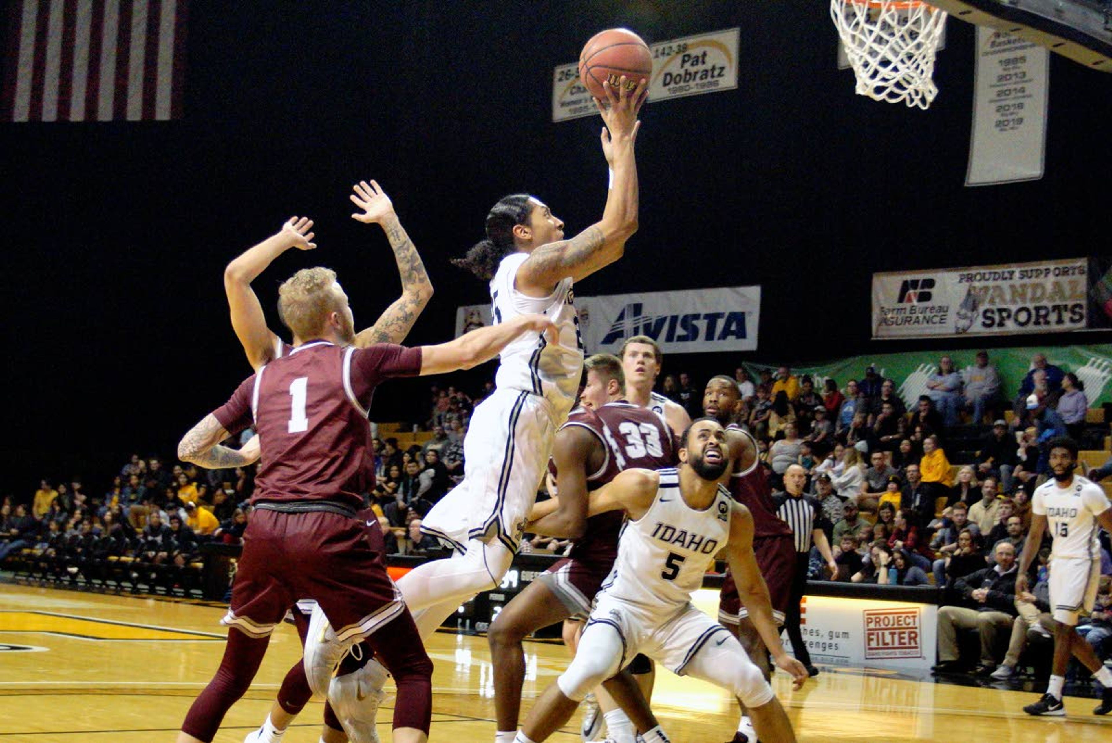 Idaho's Trevon Allen, center, sails to the hoop during the second half of a Big Sky Conference game against Montana Saturday evening.