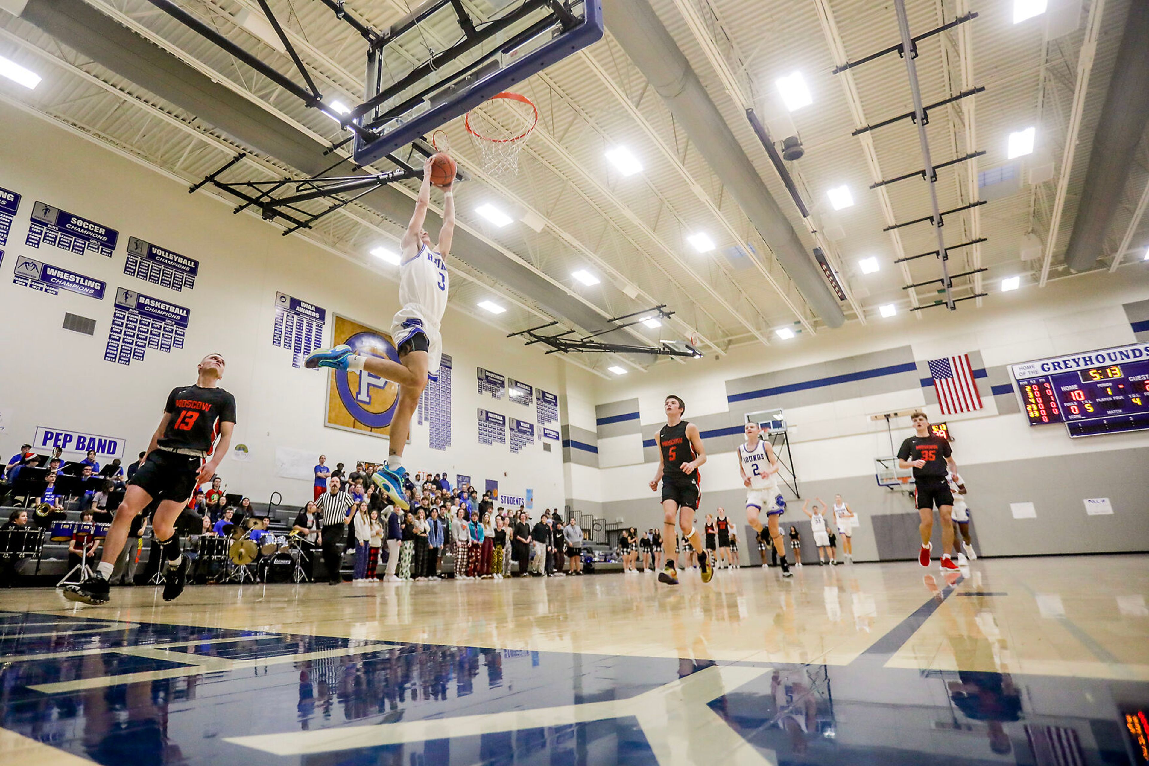 Pullman shooting guard Tanner Barbour, left, goes up for a shot during Saturday's nonleague boys basketball game against Moscow.